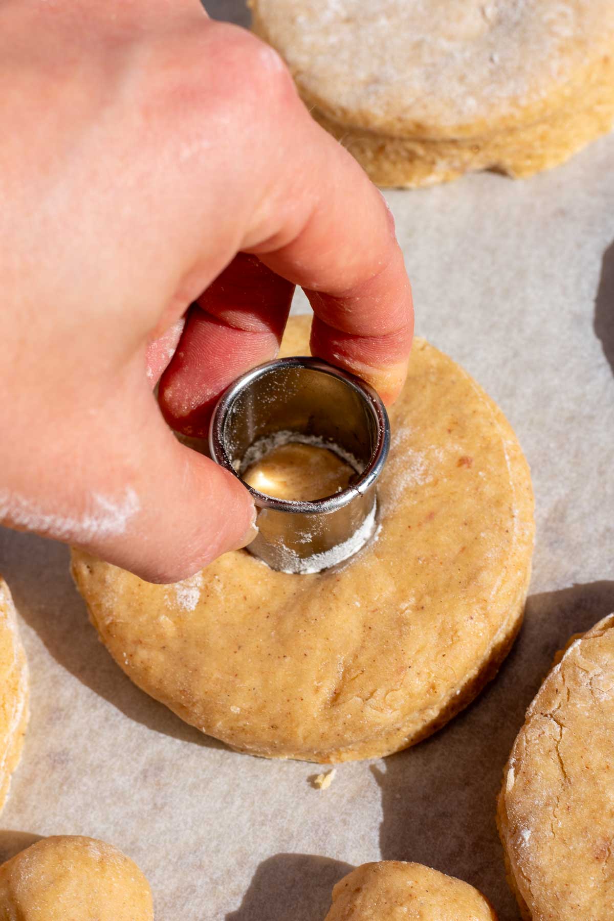 Using a small round cutter to cut out the donut holes.