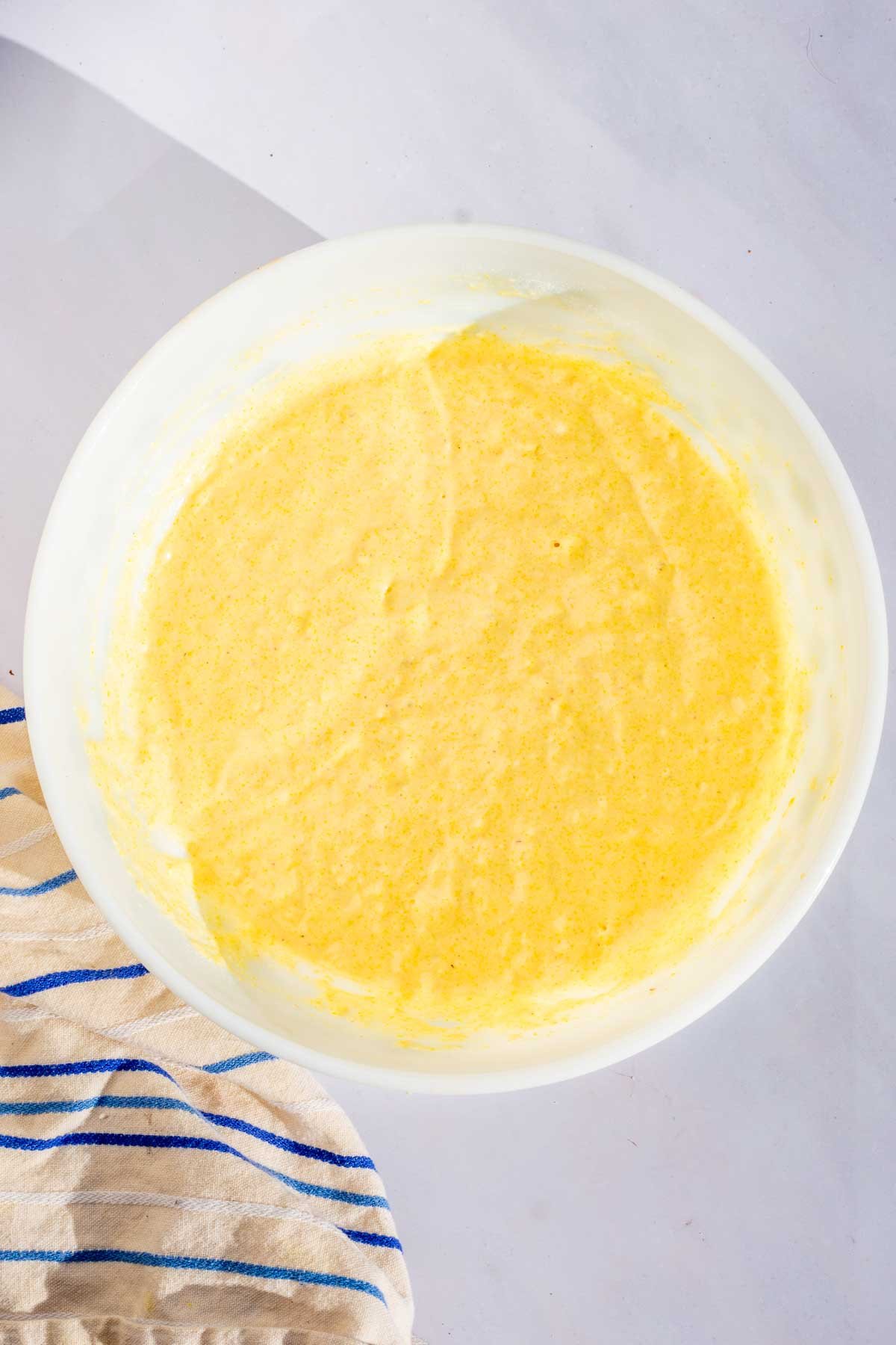 Mixed bowl of sourdough corn muffin batter.