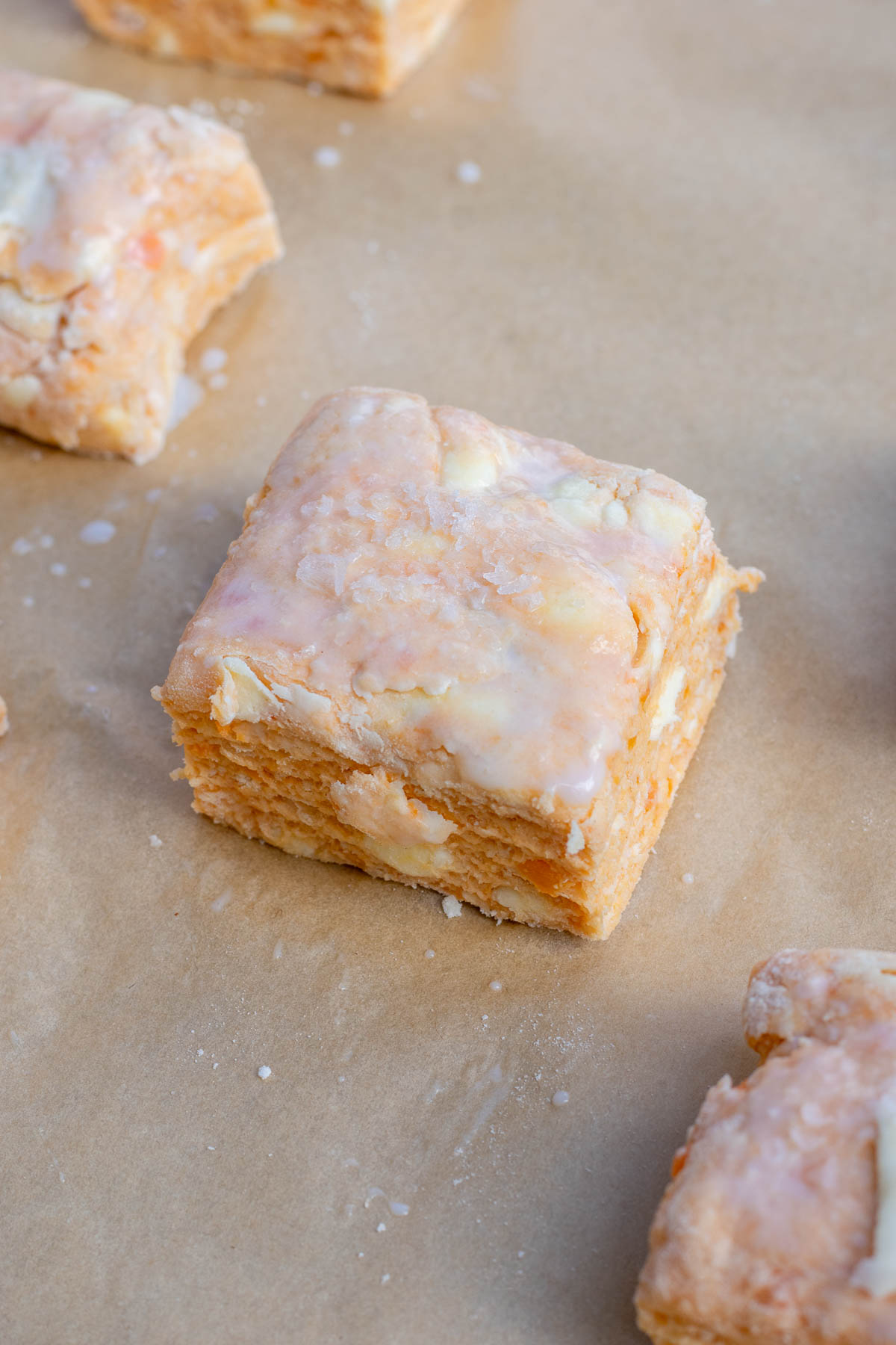 A sourdough sweet potato biscuit brushed with buttermilk and flaky salt before baking.