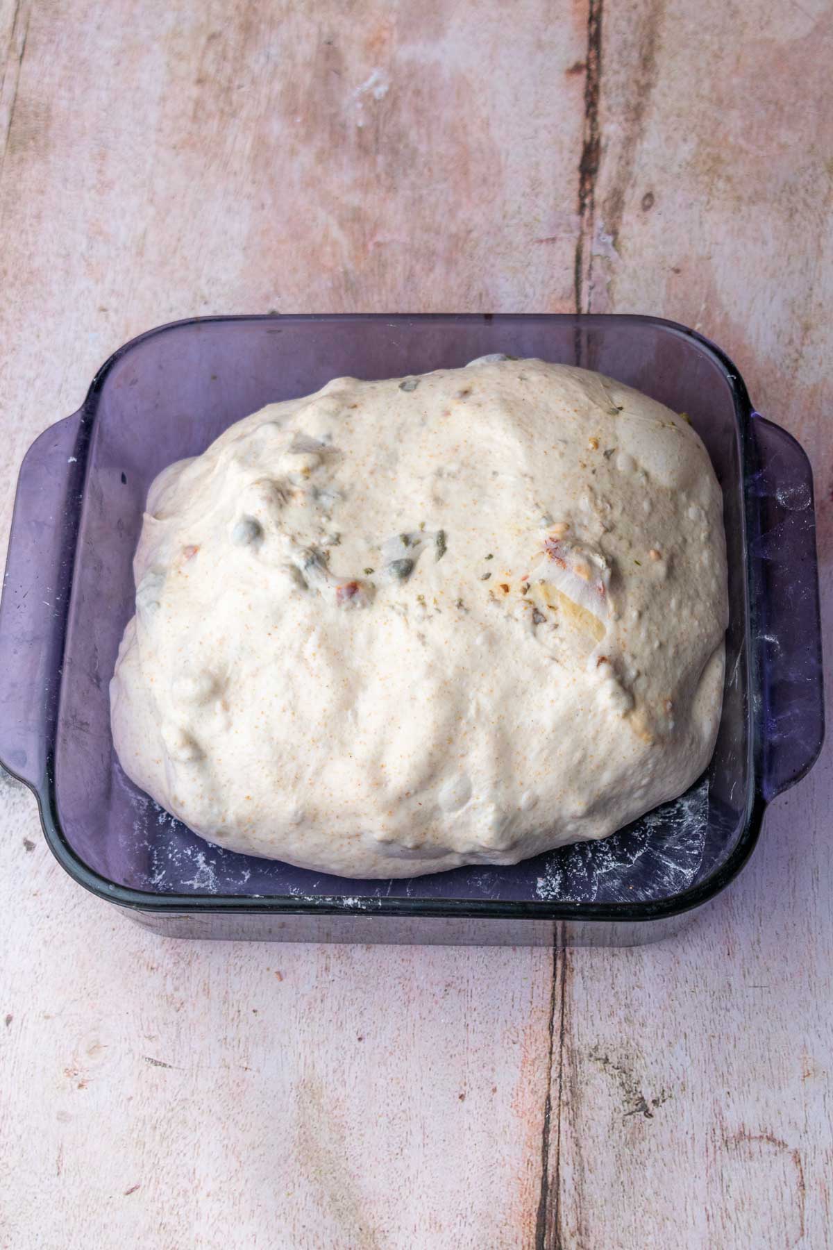 Sun-dried tomato sourdough bread at the end of bulk fermentation.