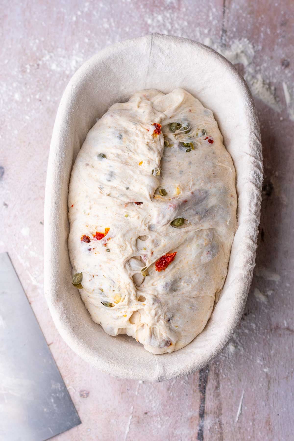 Sun-dried tomato sourdough bread shaped in banneton.