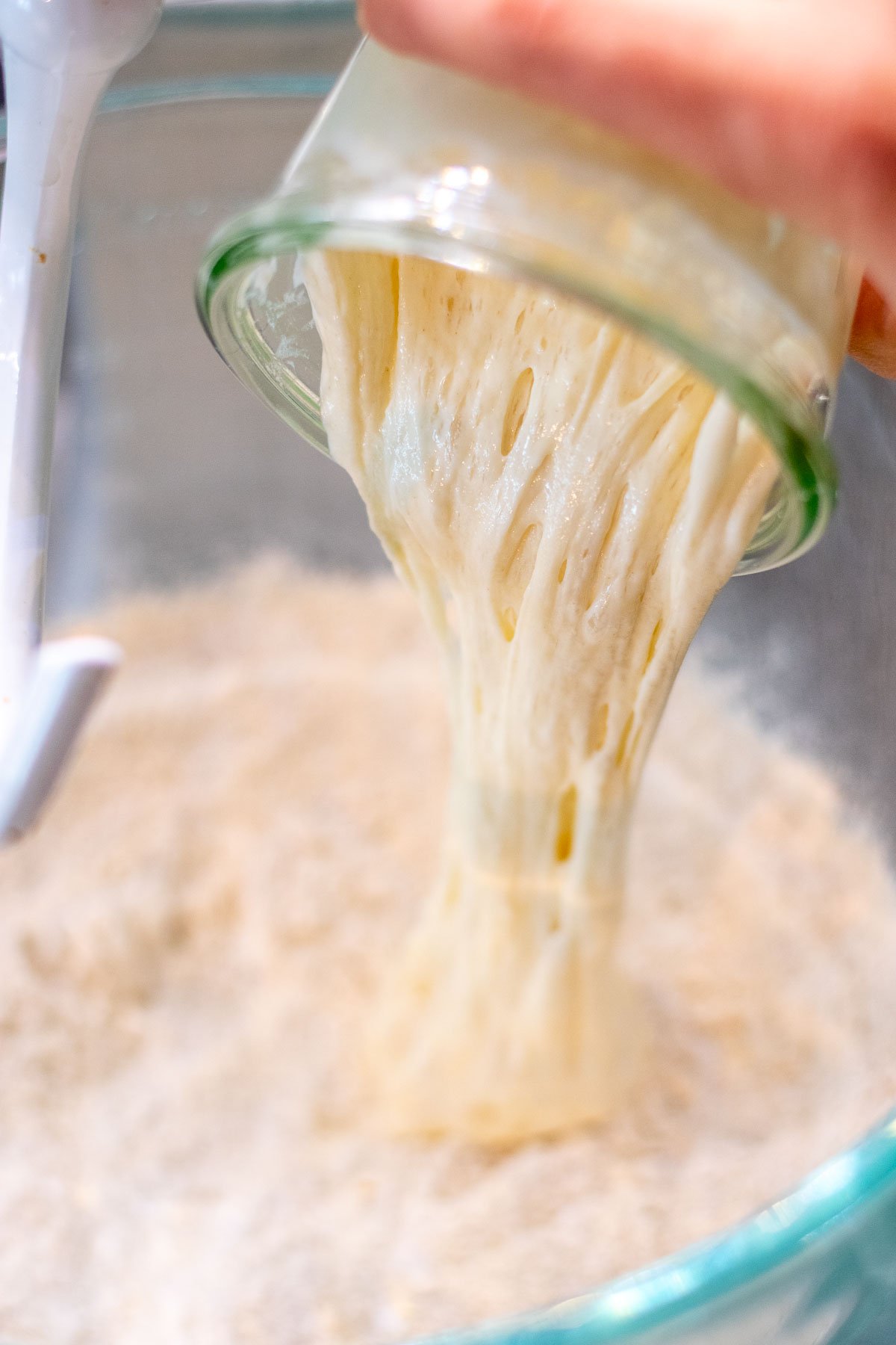 Pouring levain into dry ingredients.