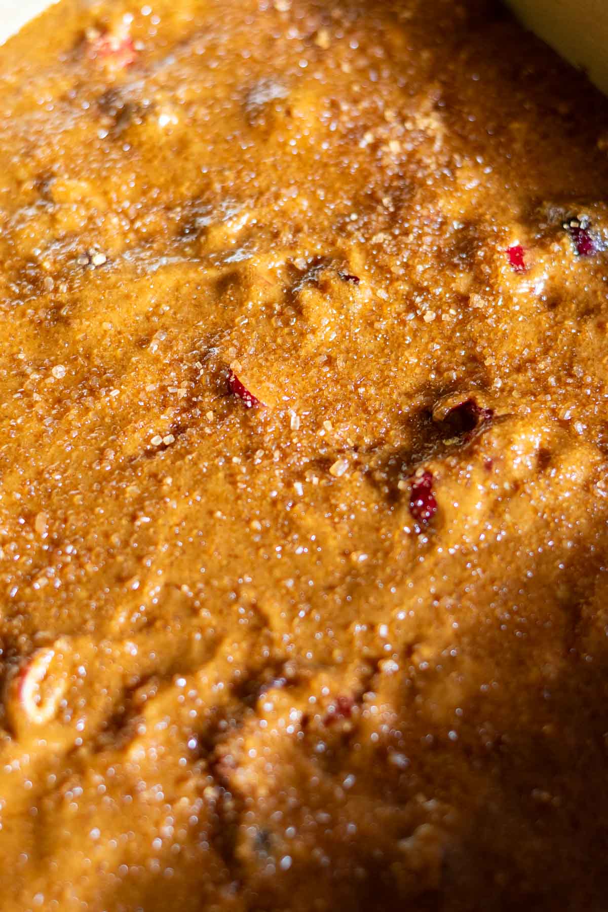 Demerara sugar sprinkled on top of sourdough gingerbread cake.