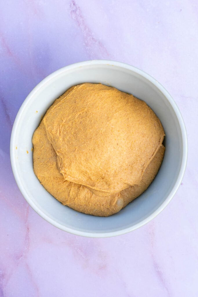 Sourdough anadama bread in bowl and doubled in size at the end of bulk fermentation.