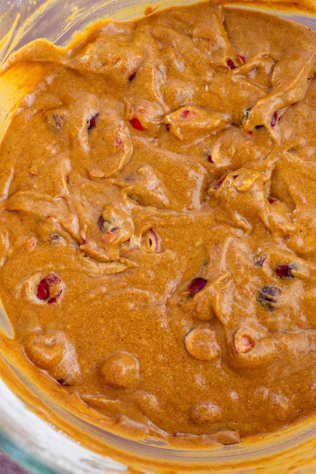 Mixed sourdough gingerbread cake batter with cranberries.