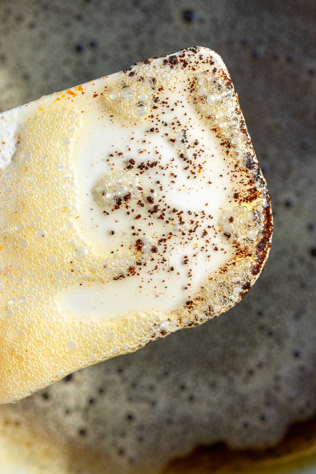 Specks of brown butter on a spatula.