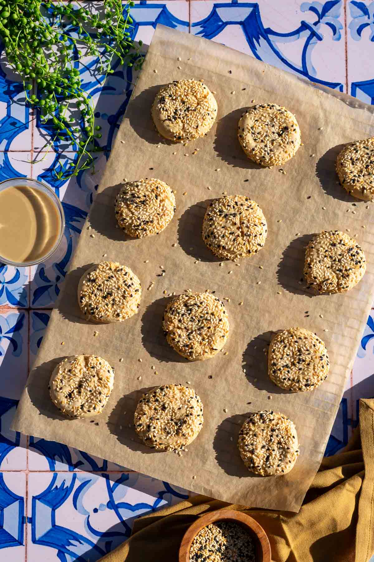 12 baked sourdough tahini honey cookies on a parchment lined baking sheet.