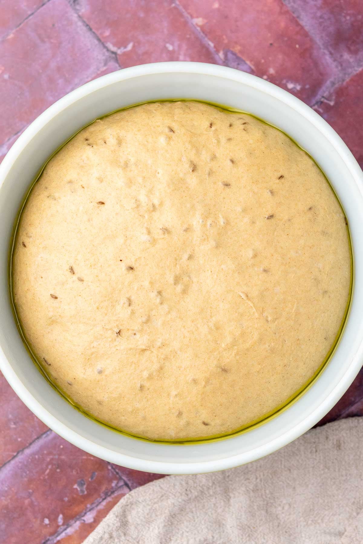 Sourdough rye sandwich bread dough in a bowl at the end of bulk fermentation and doubled in size.