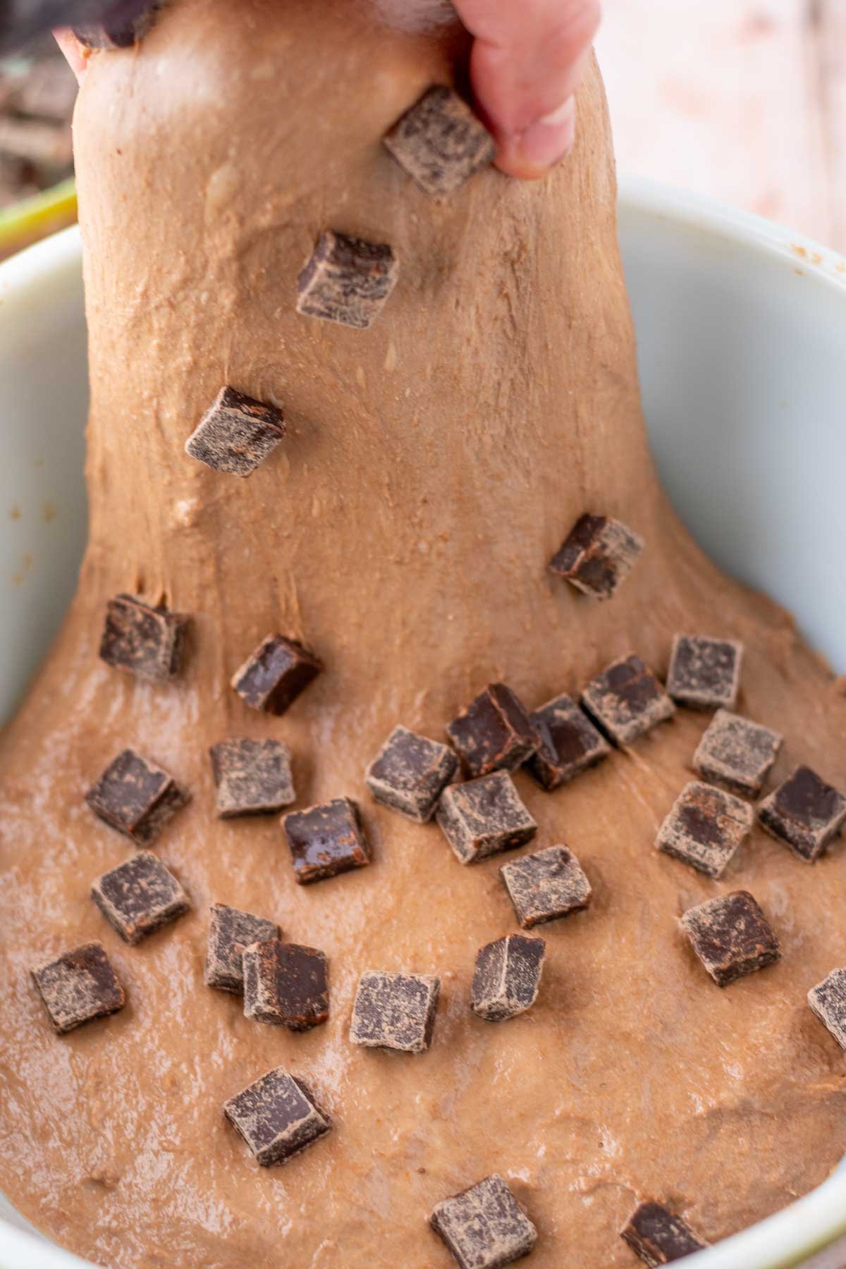 Stretch and folding chopped chocolate chunks into chocolate coffee sourdough bread.