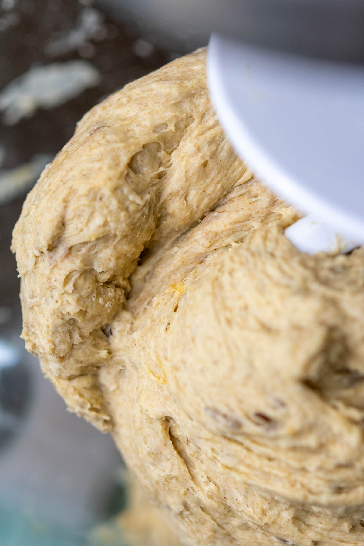 Close up of mixing the sourdough rye sandwich bread in a stand mixer with the dough hook attachment.