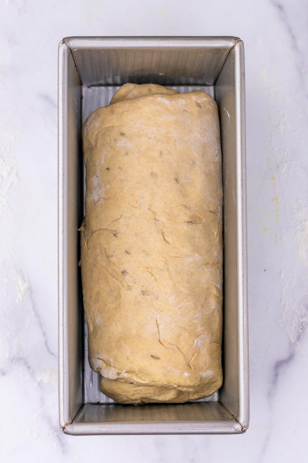 Sourdough rye sandwich bread dough at the start of final proof in a pullman sandwich bread pan.