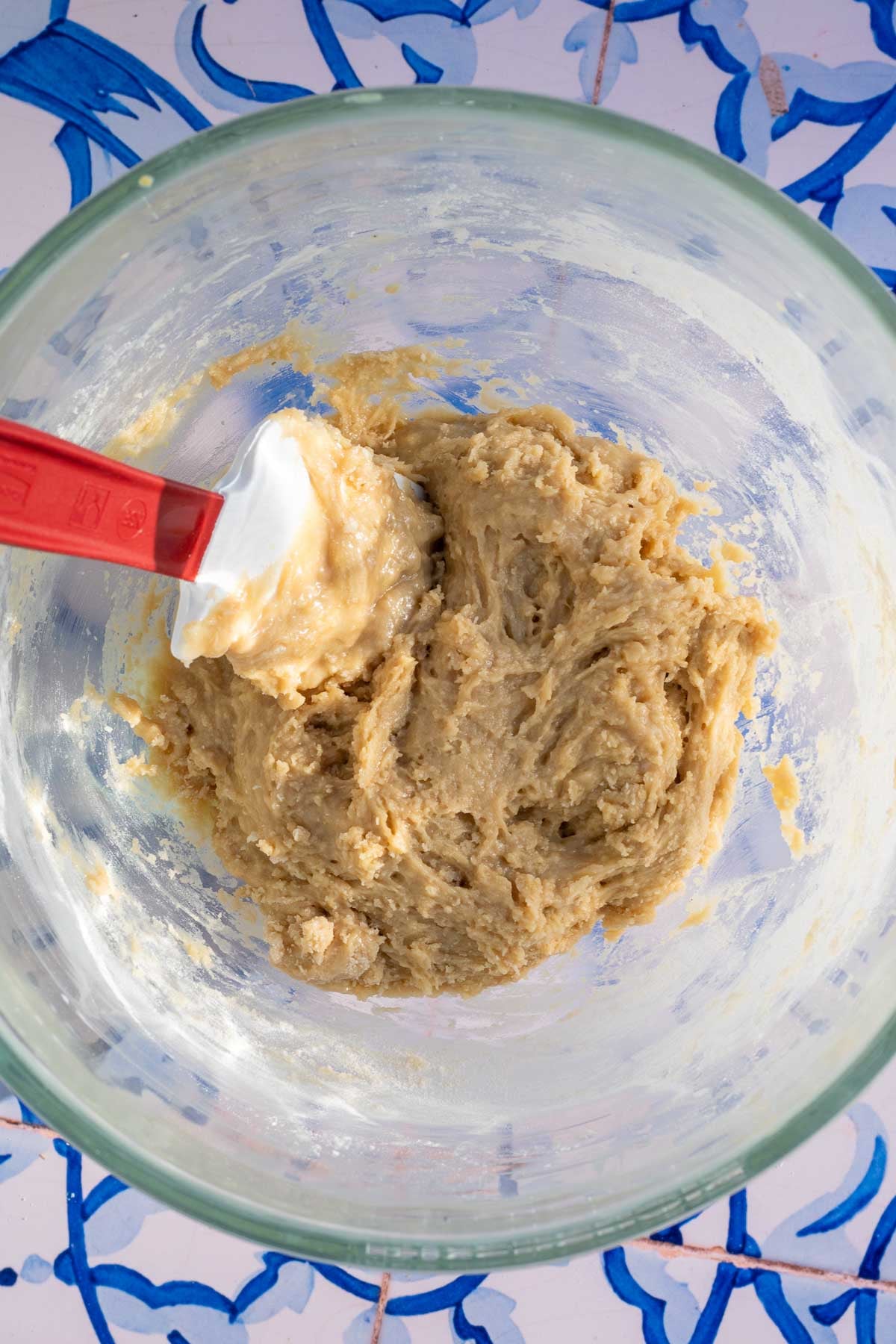 Bowl and spatula of mixed sourdough tahini honey cookie dough.