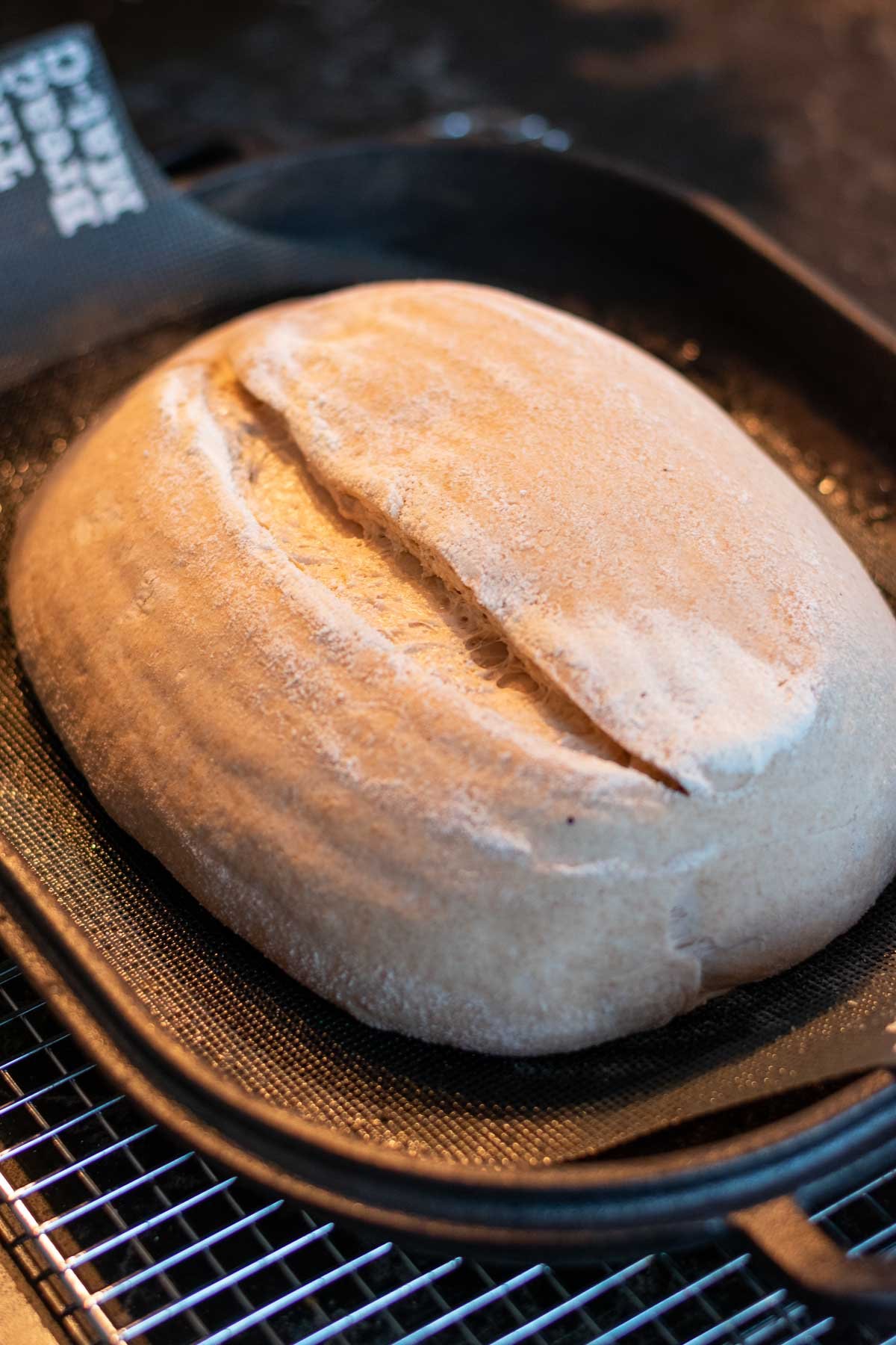 Scored emmer sourdough bread in Challenger Bread Pan before baking.