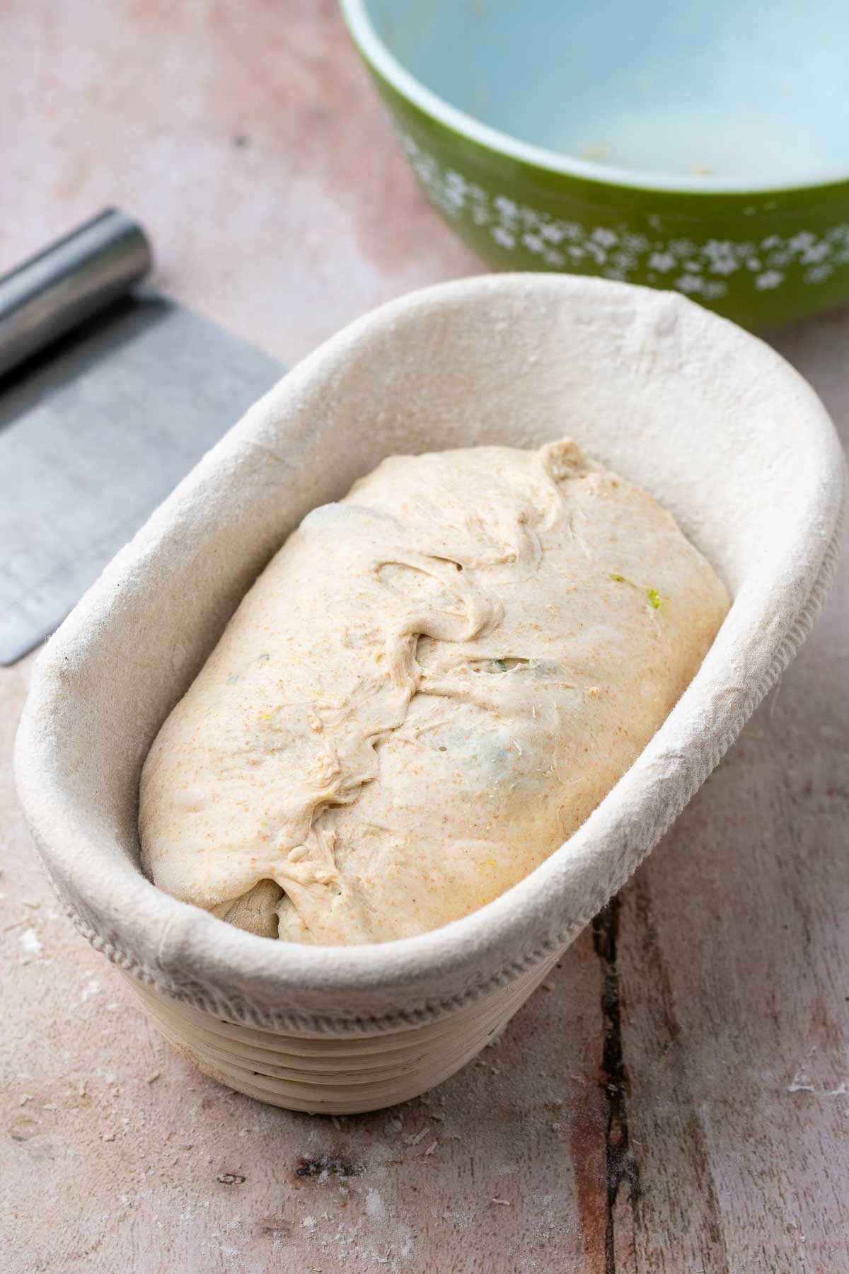 Shaped olive sourdough bread in a banneton.