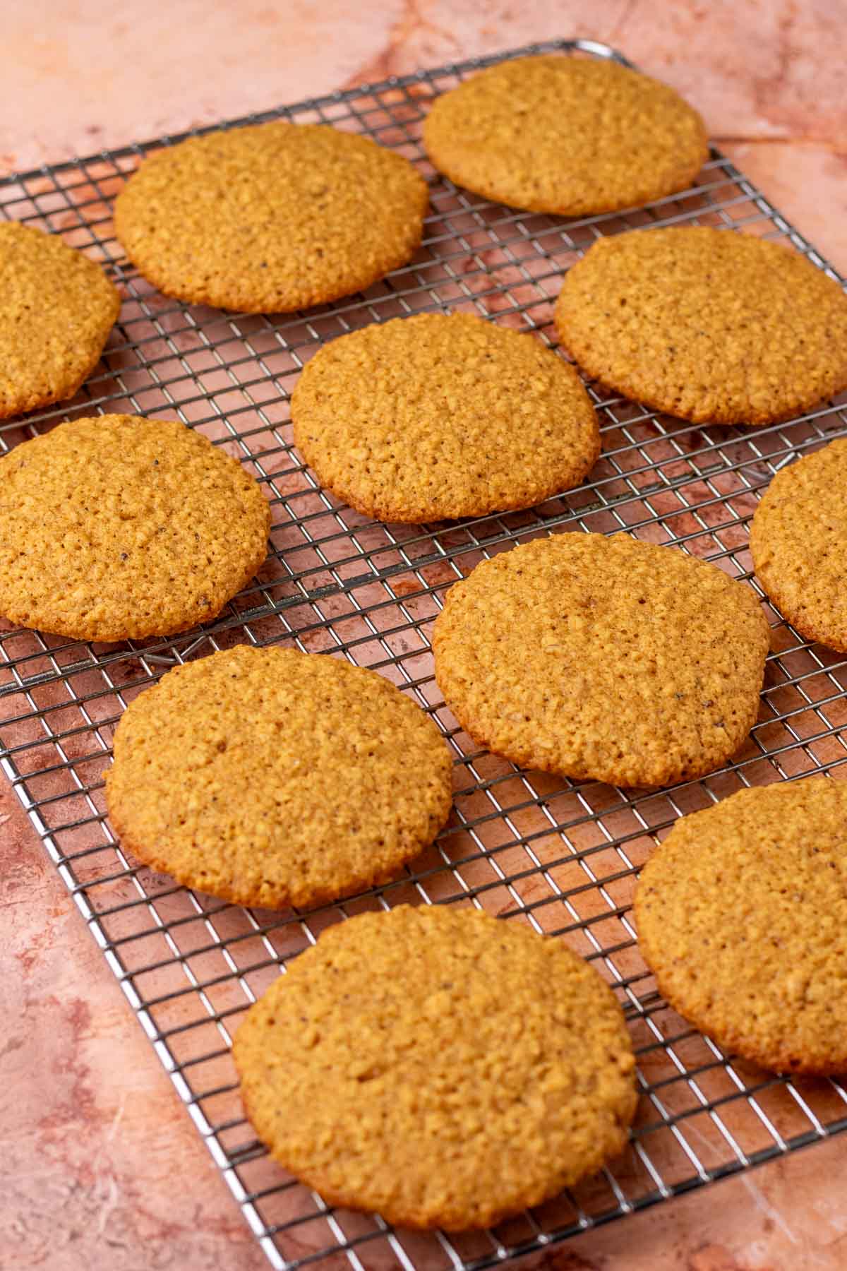 Baked sourdough oatmeal cookies on a wire rack.