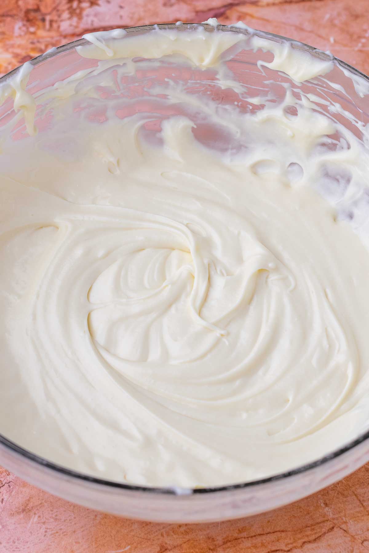 Bowl of mixed cream cheese filling for sourdough oatmeal cream pies.