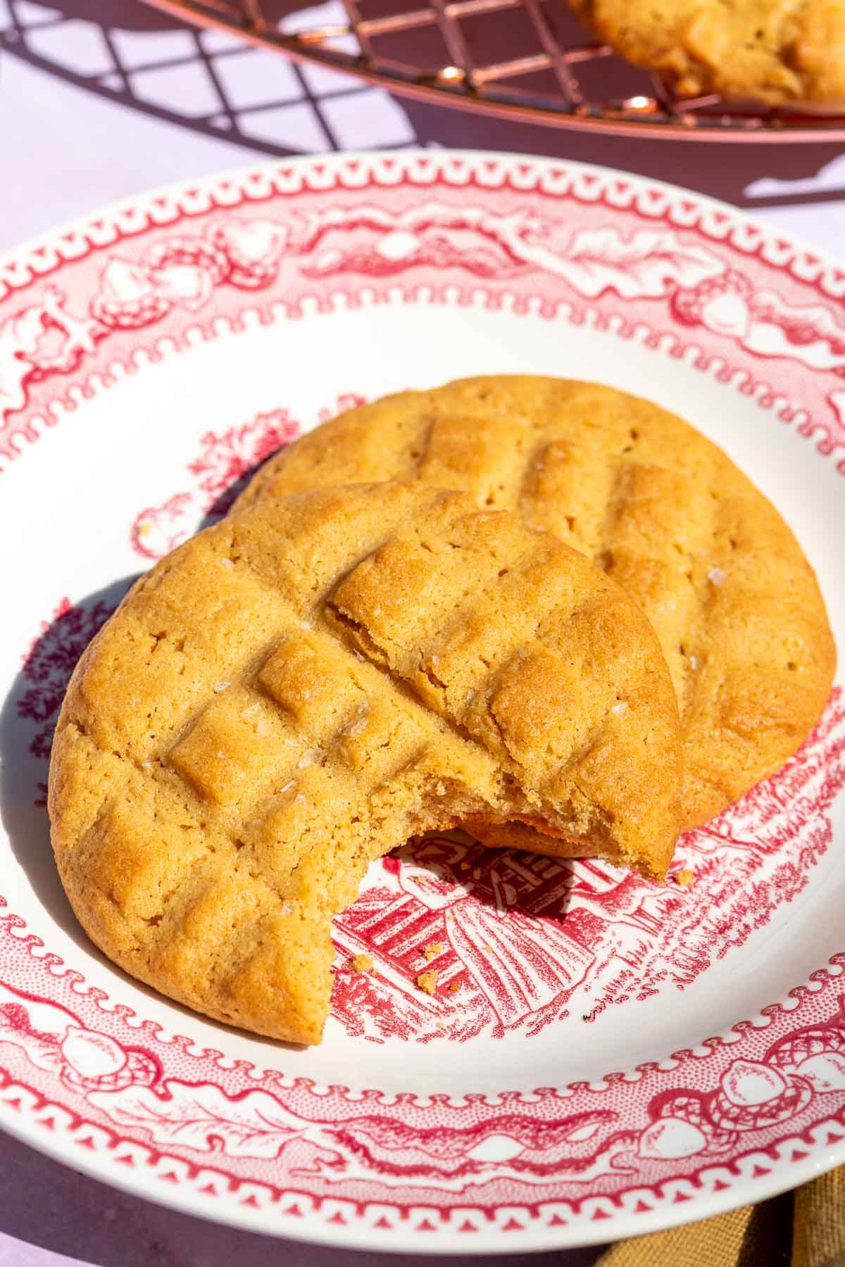 Plate of sourdough peanut butter cookies with bite taken out of one.