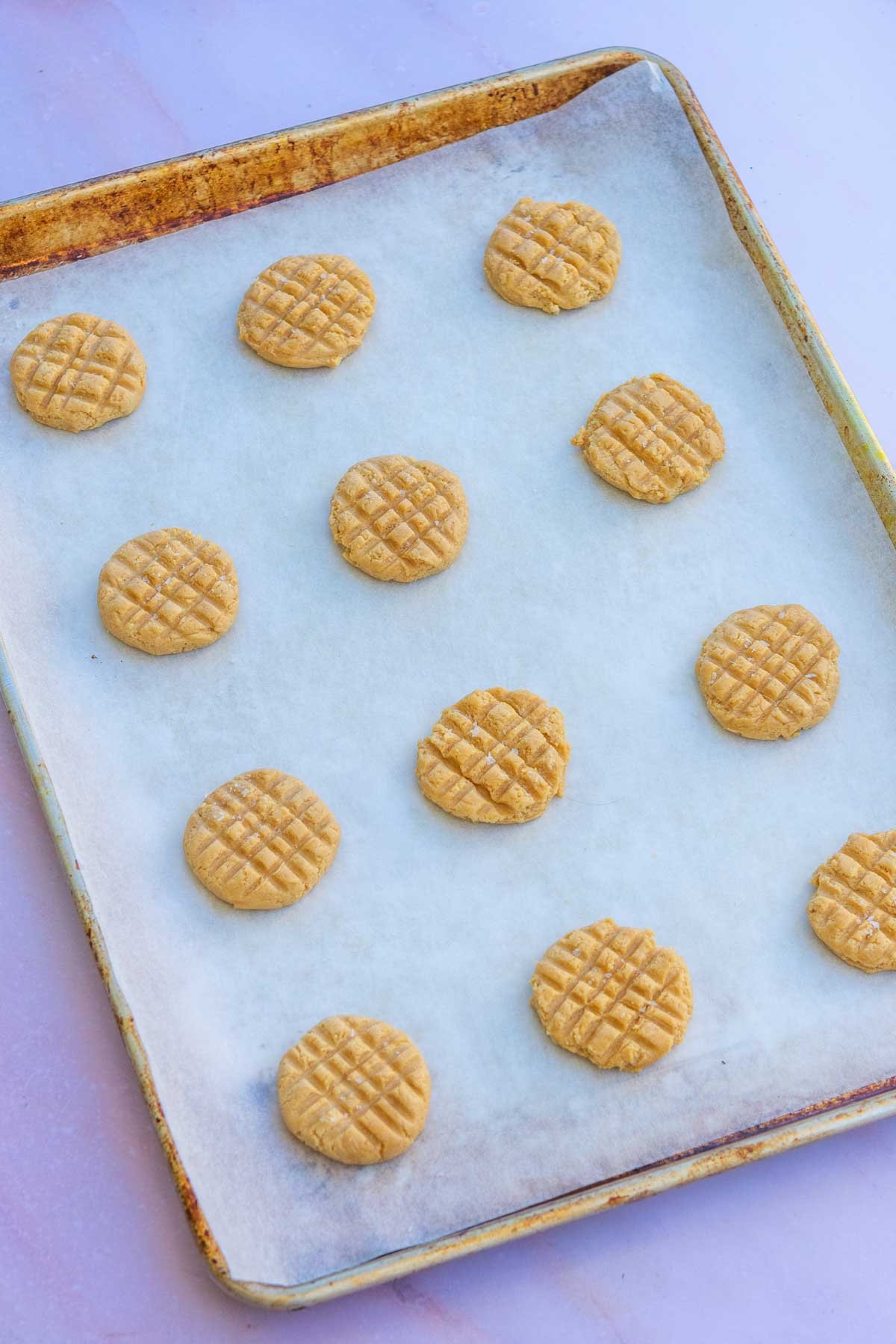 Sourdough peanut butter cookies baked on a sheet pan.