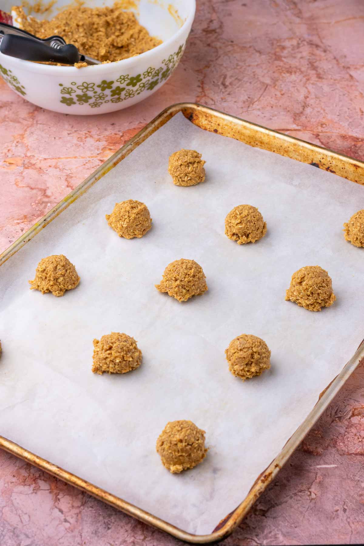 Sheet pan with unbaked sourdough oatmeal cookies.