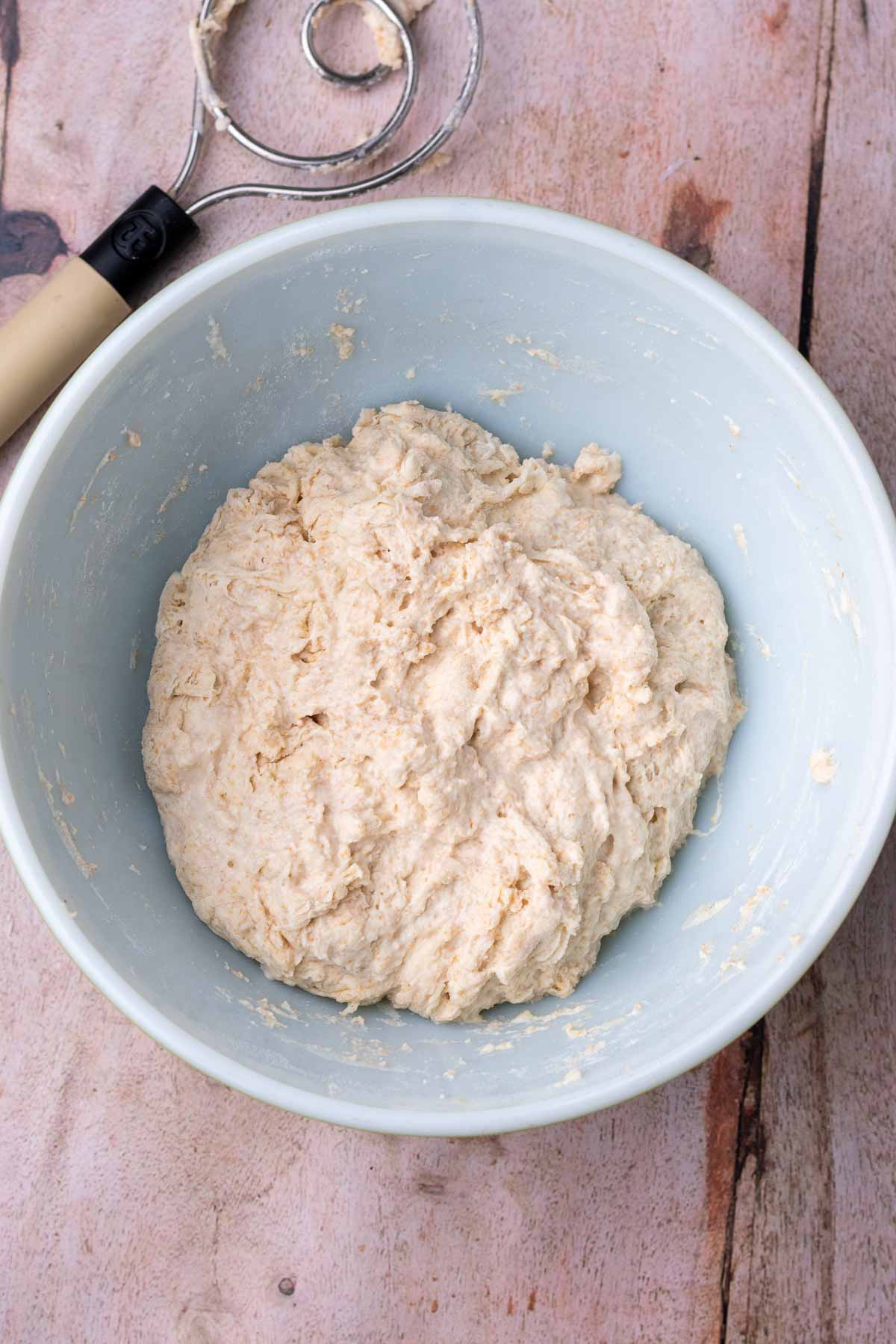Dough mixed at the starter of autolyse in a bowl.