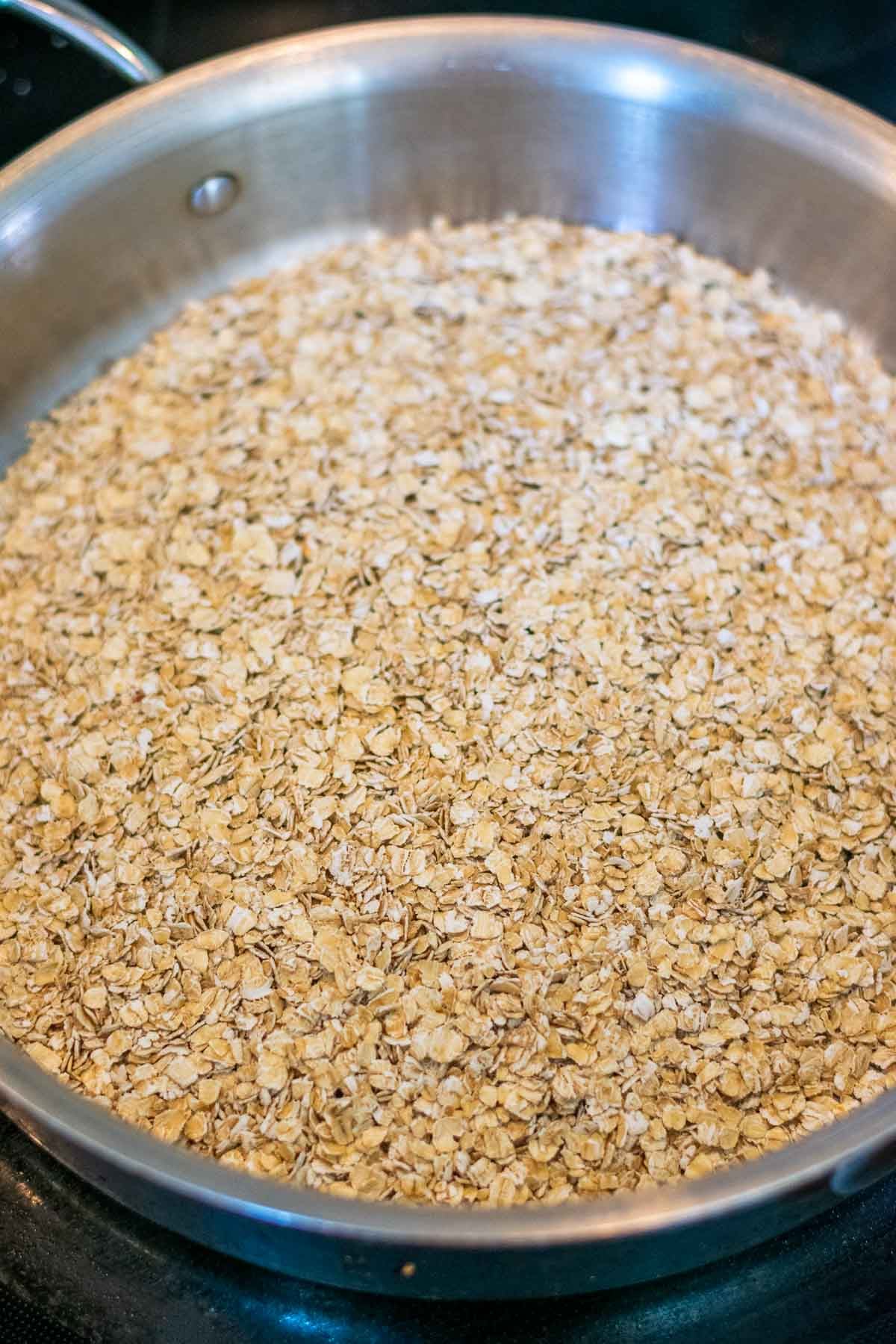 Toasting oats in a skillet.