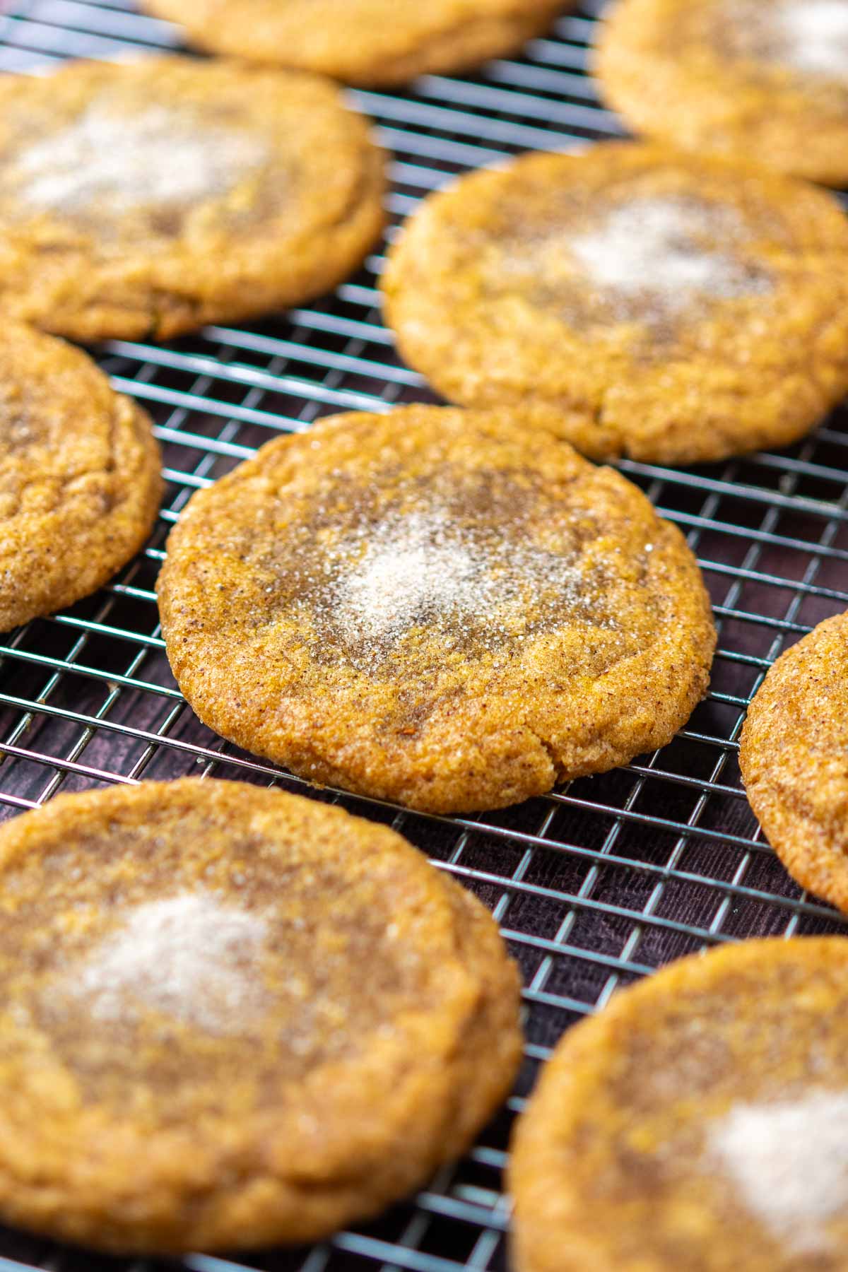 Baked sourdough pumpkin maple cookies on a wire rack.