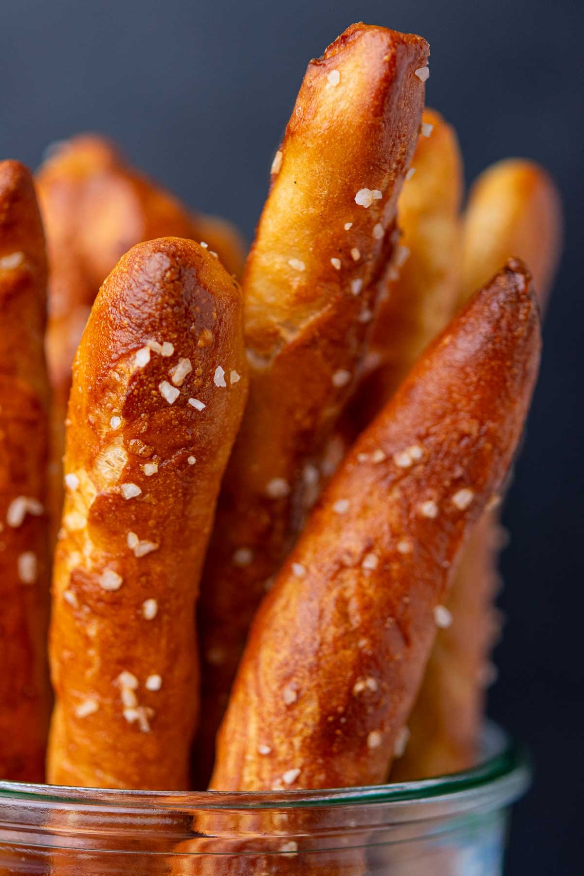Detail of hard sourdough pretzel rods in jar.