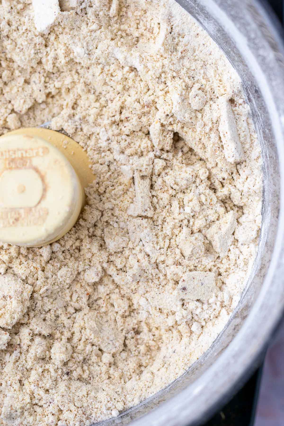 Food processor with dry ingredients for sourdough pumpkin pecan pancakes mixed.