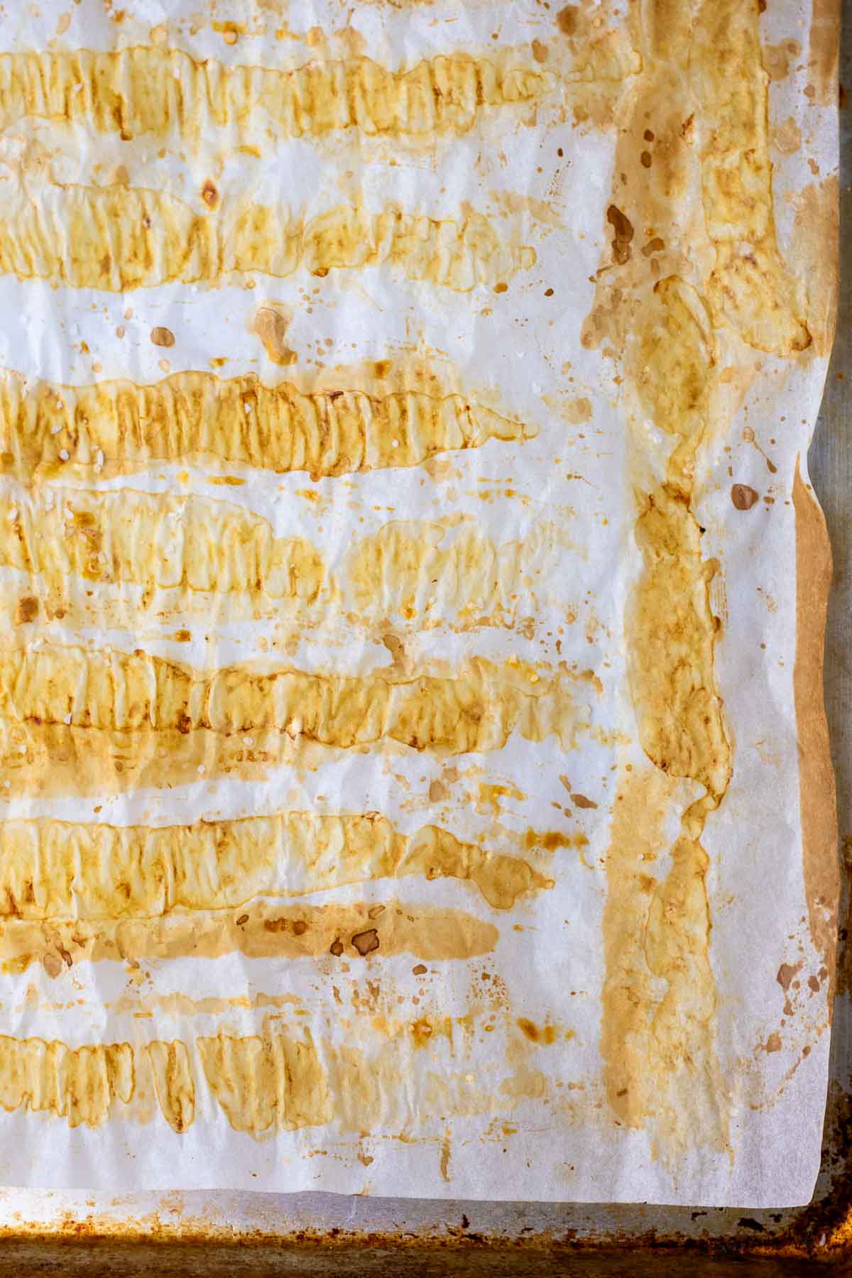 Imprints of sourdough pretzel rods on a baking sheet.