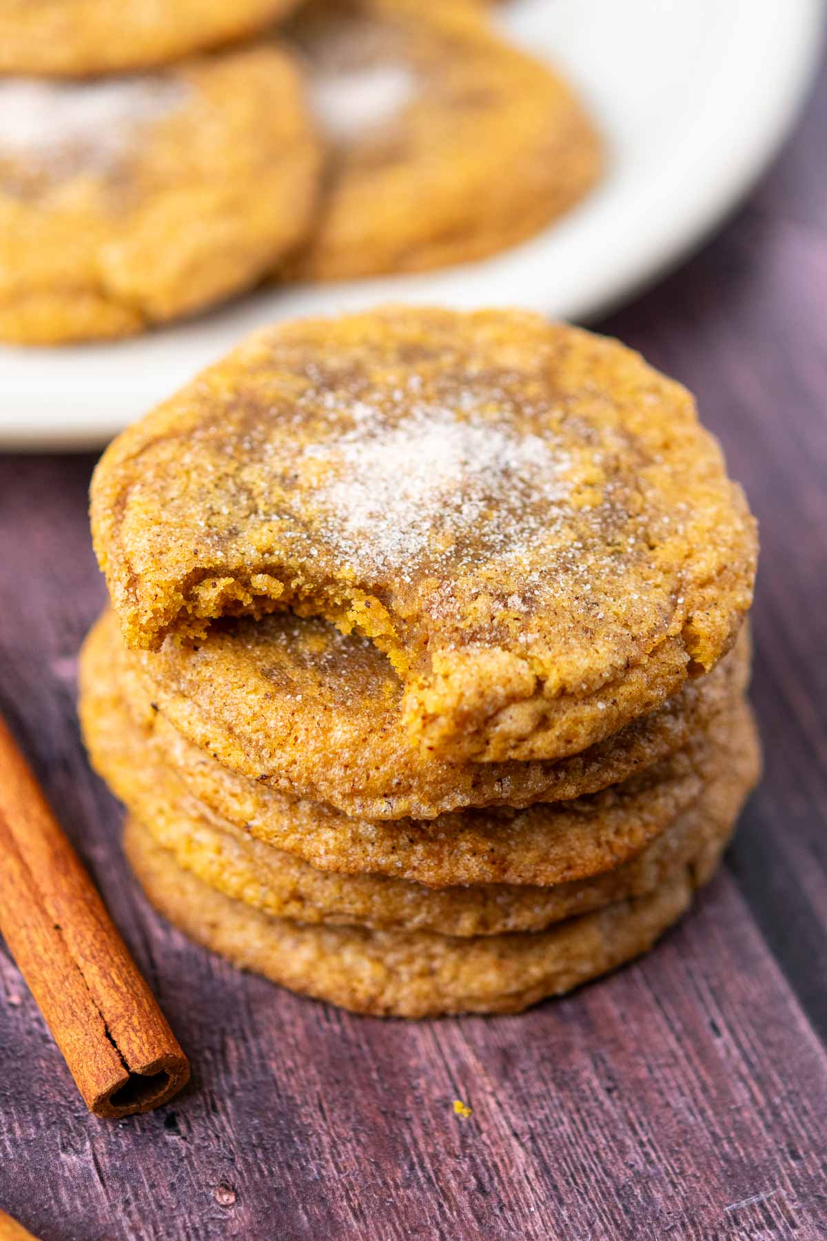 Stack of sourdough pumpkin cookies with bite taken out of the top one.