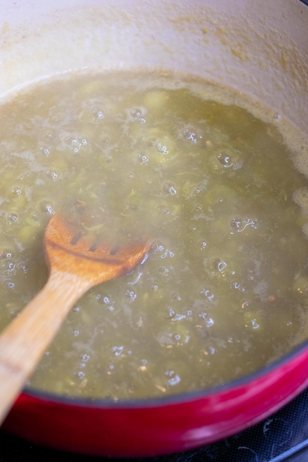 Cooking Concord grape pulp in Dutch oven.
