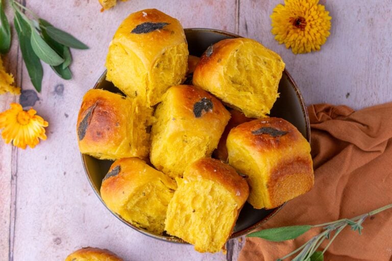 Bowl of sourdough sweet potato dinner rolls with sage.