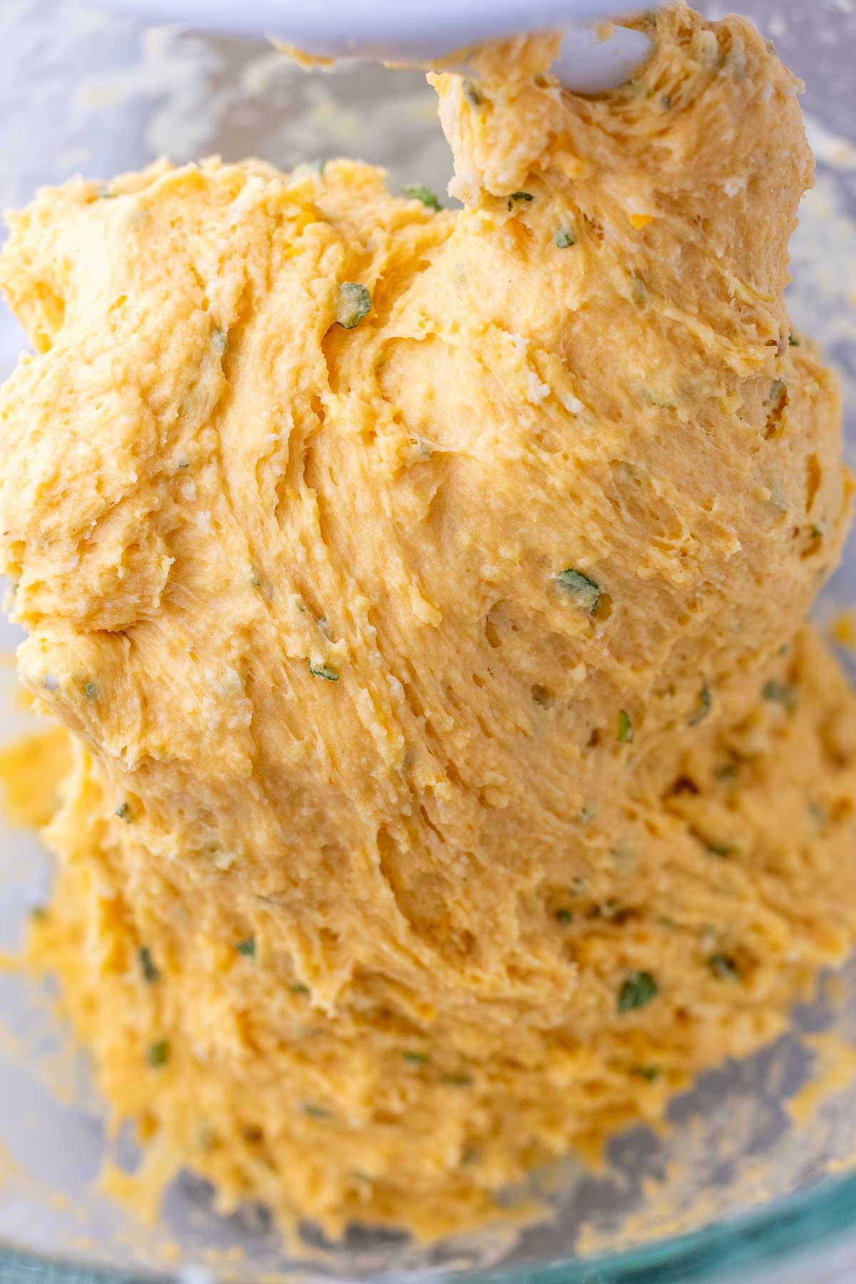 Mixed and sticky sourdough sweet potato dinner roll in stand mixer.