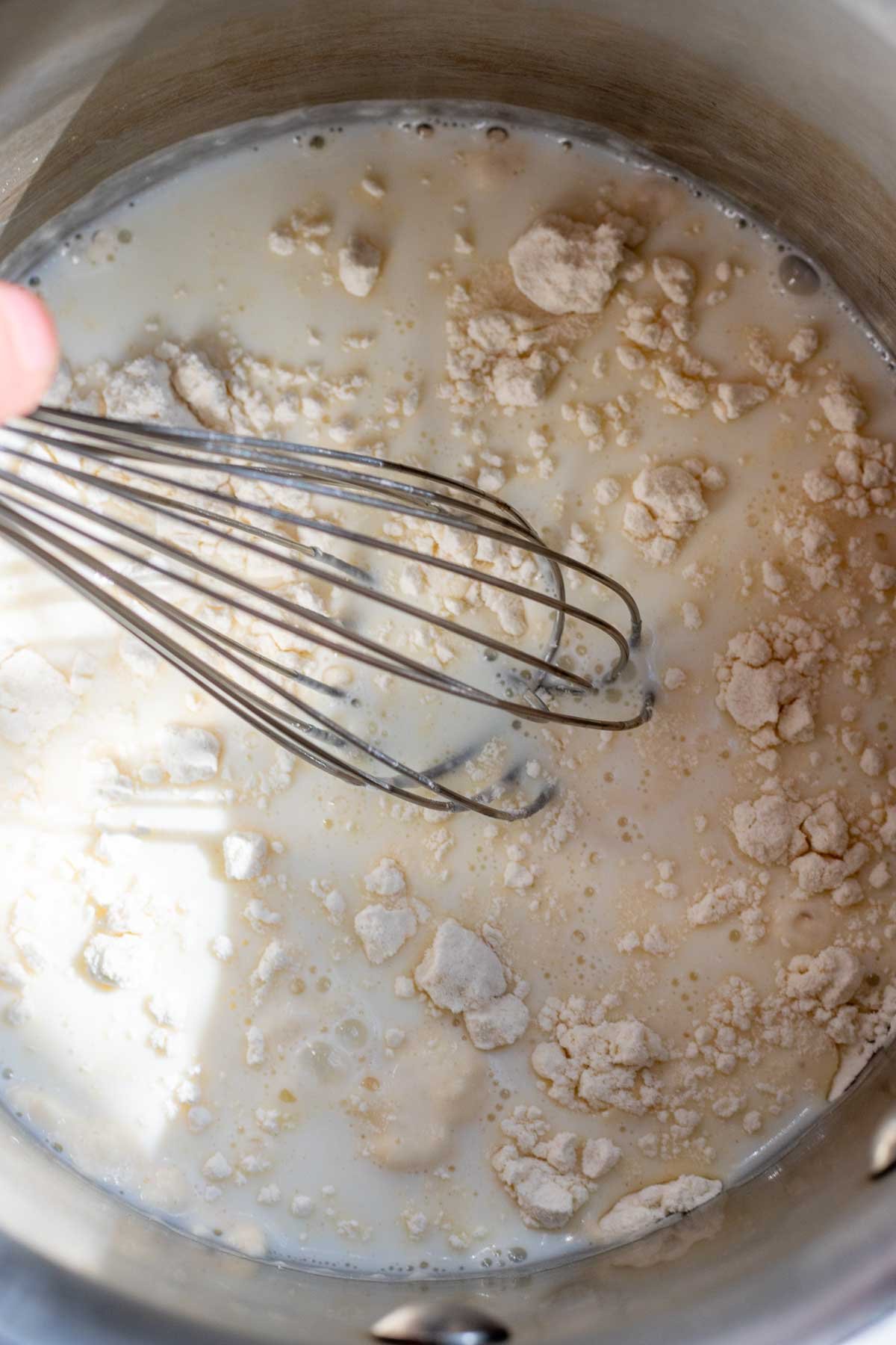 Flour and water for tangzhong in saucepan with a whisk.