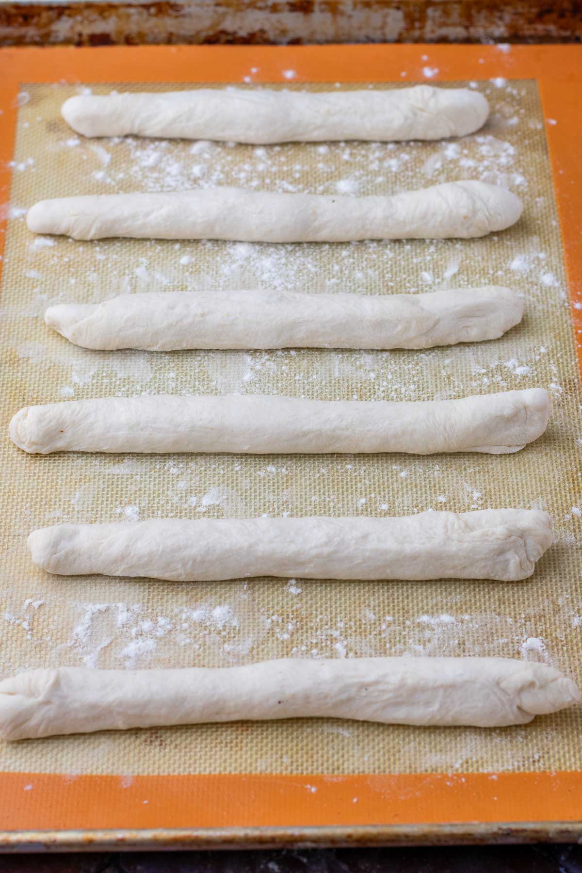 Sourdough breadsticks on baking sheet at the start of final proof.