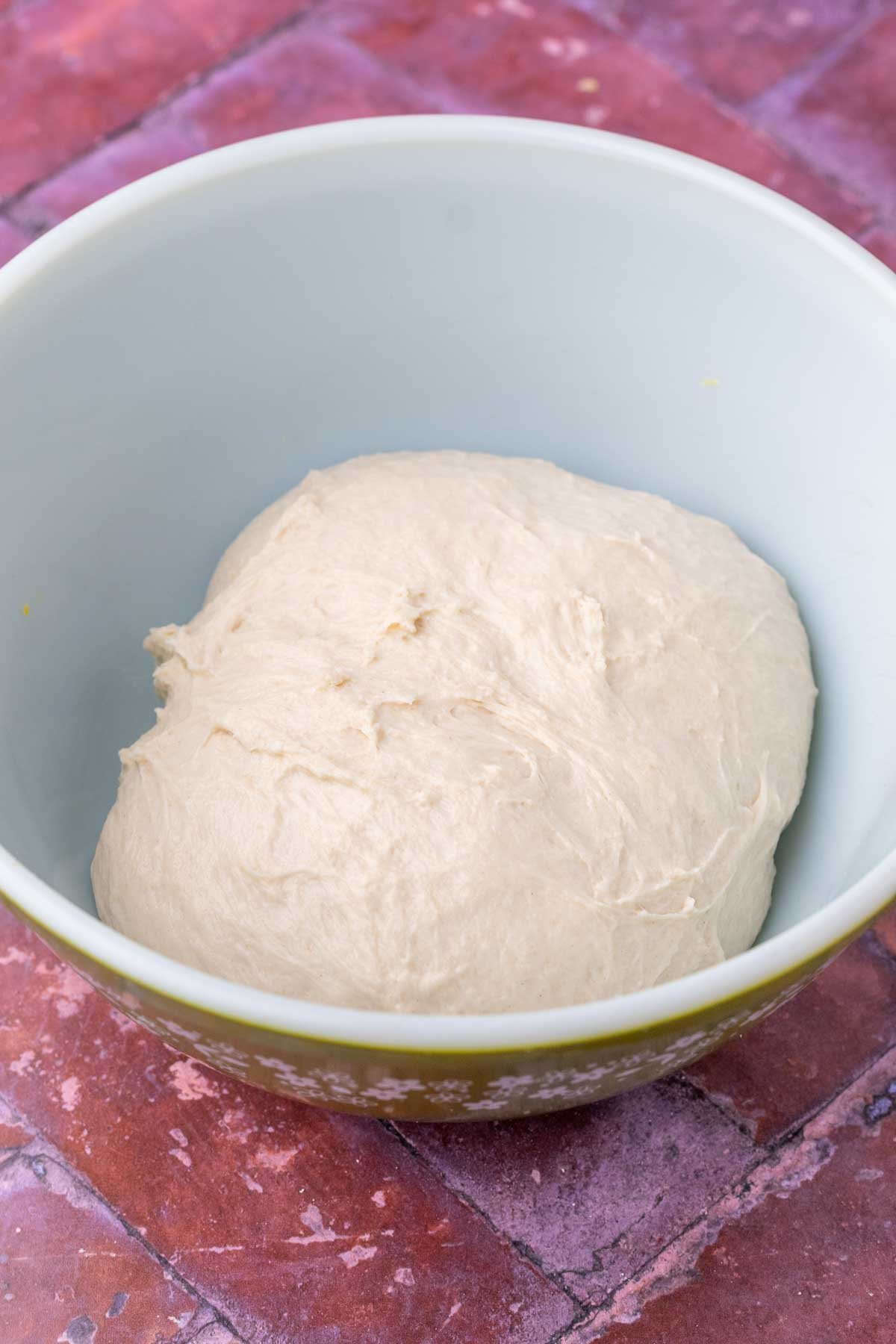 Sourdough breadstick dough in bowl at the start of bulk fermentation.