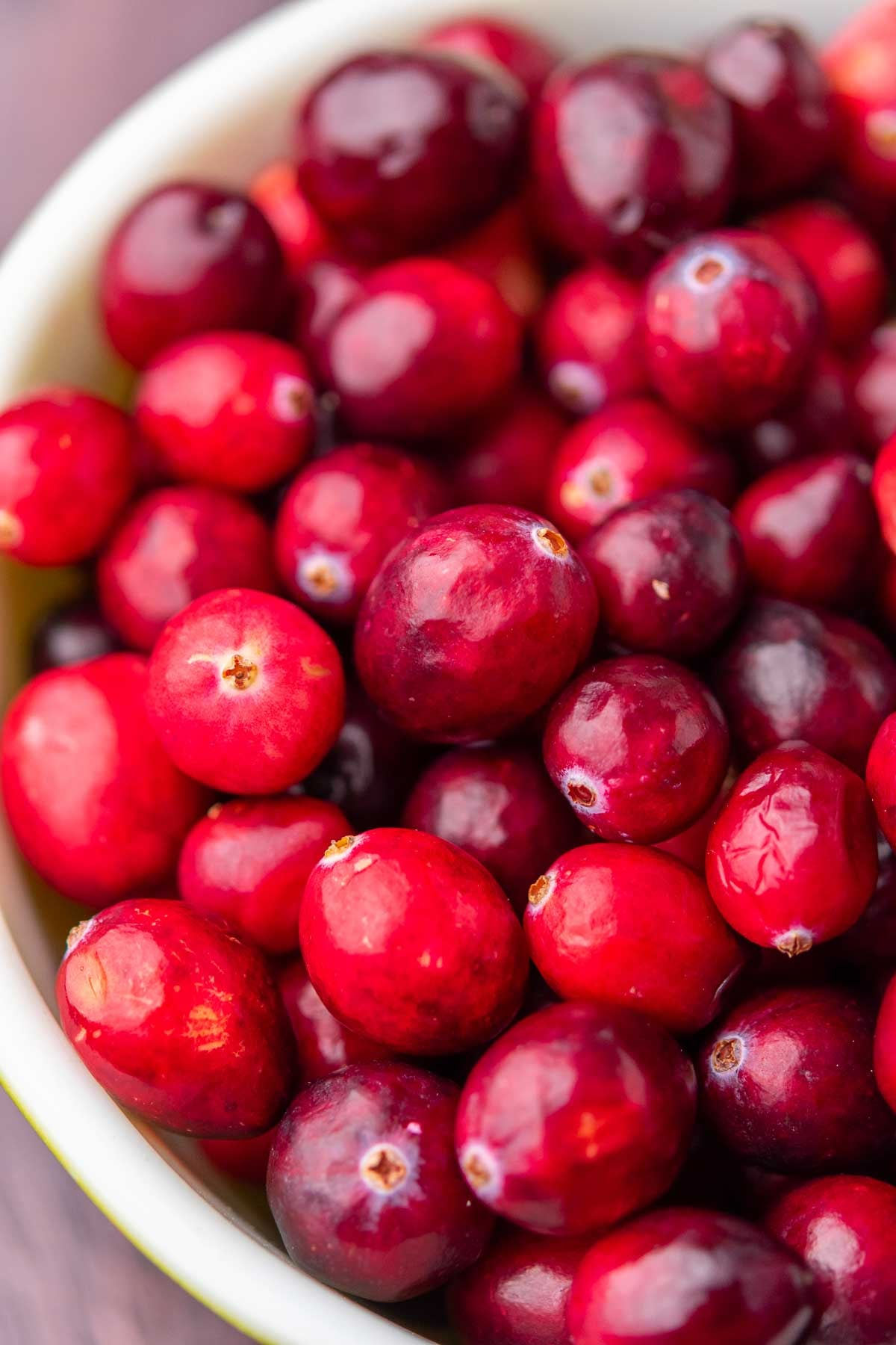 Close up detail of a bowl of fresh cranberries.