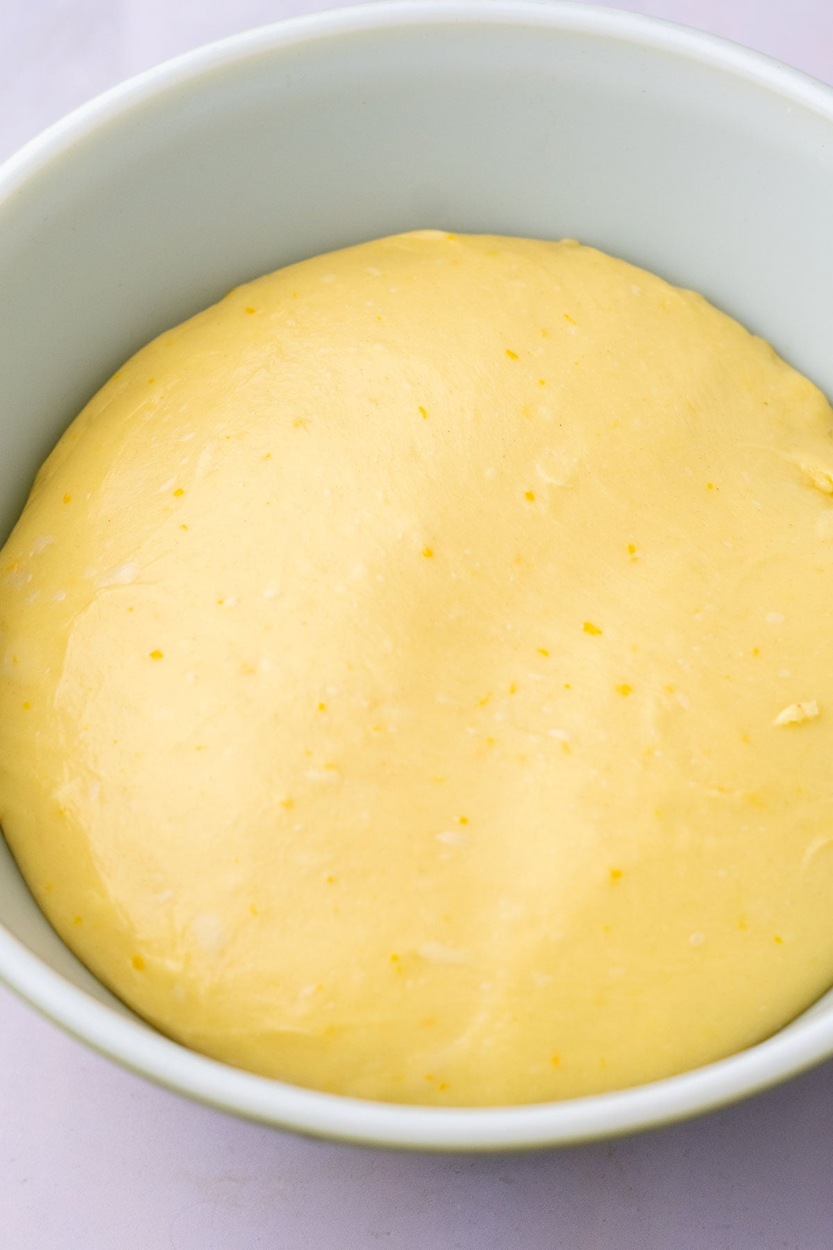 Sourdough maple pecan sticky bun at the end of bulk fermentation in a bowl.