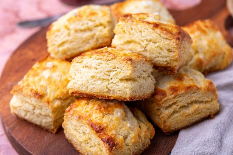 Flaky sourdough biscuits on a platter.