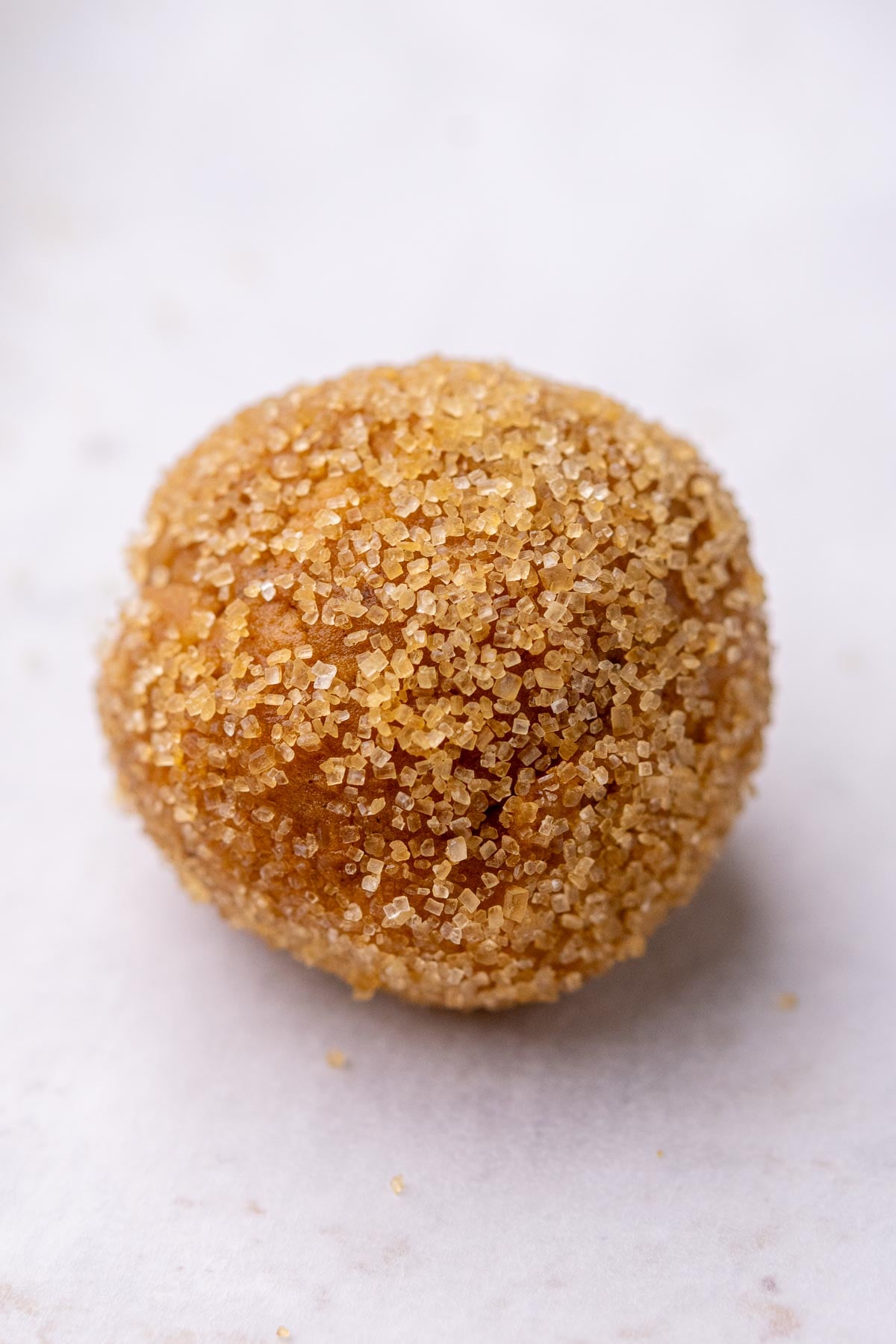 Unbaked Sourdough ginger molasses cookie rolled in raw sugar.