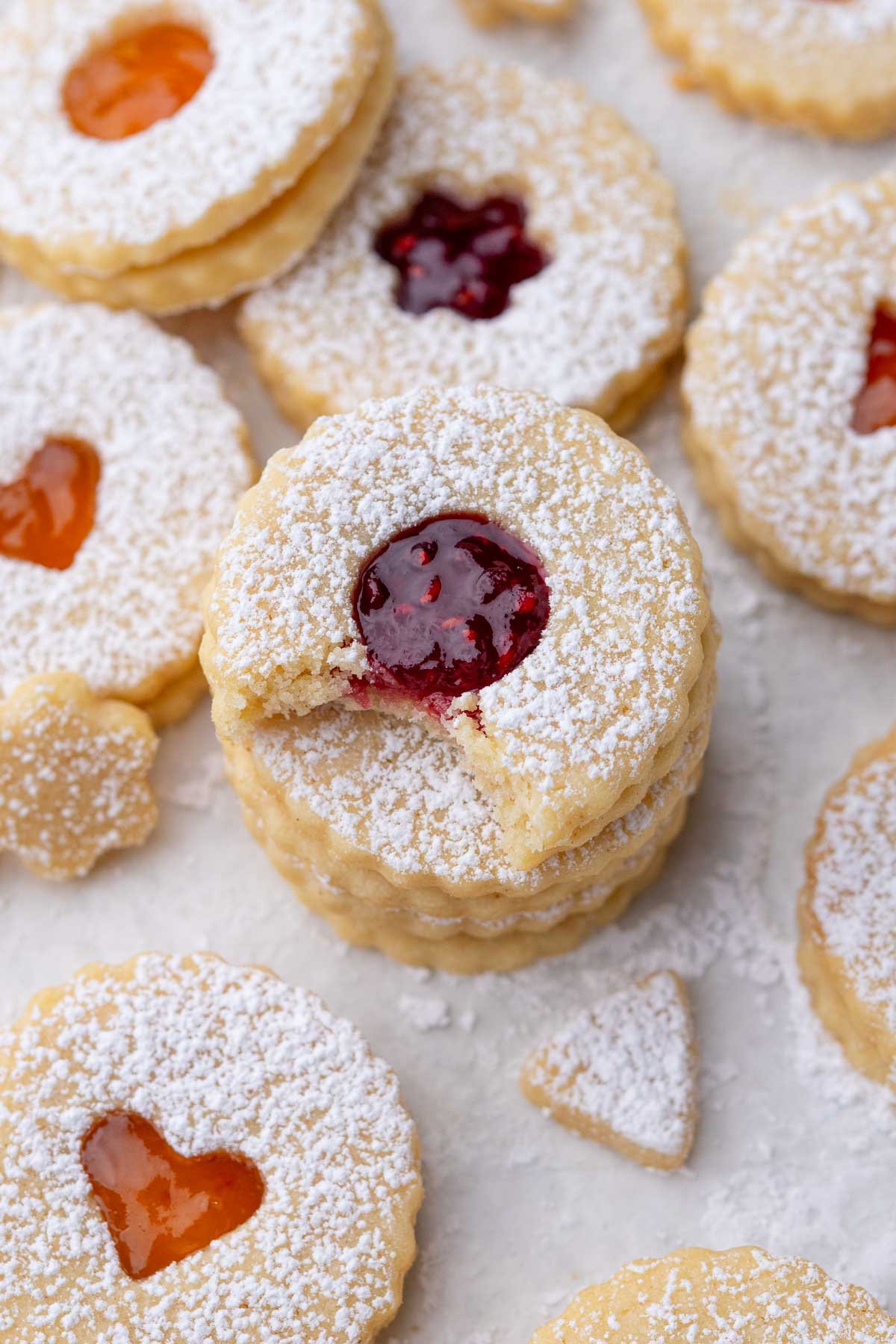 Sourdough Linzer Cookies with fruit jam and dusted with powdered sugar.