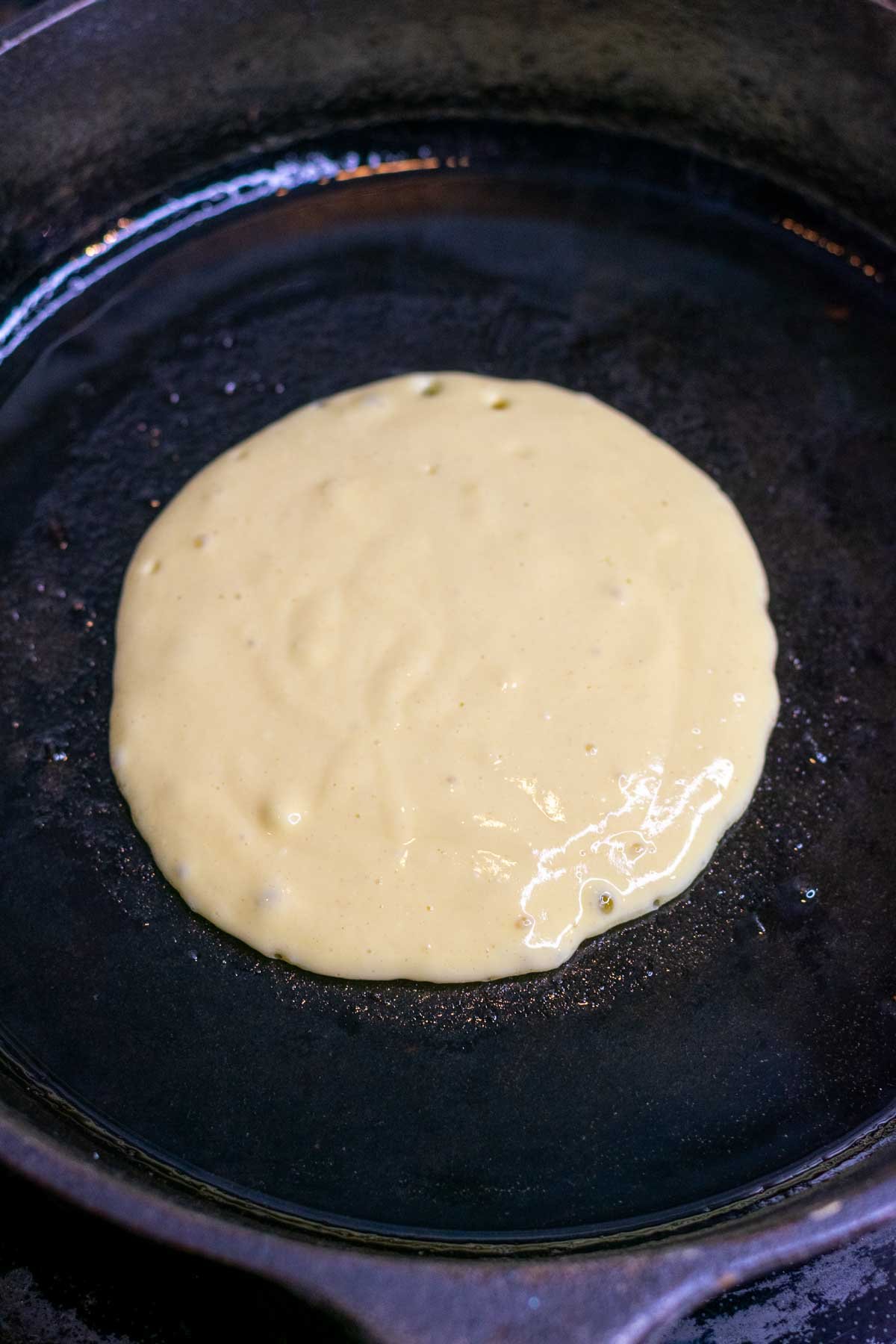 Cooking sourdough cottage cheese pancake in a pan.