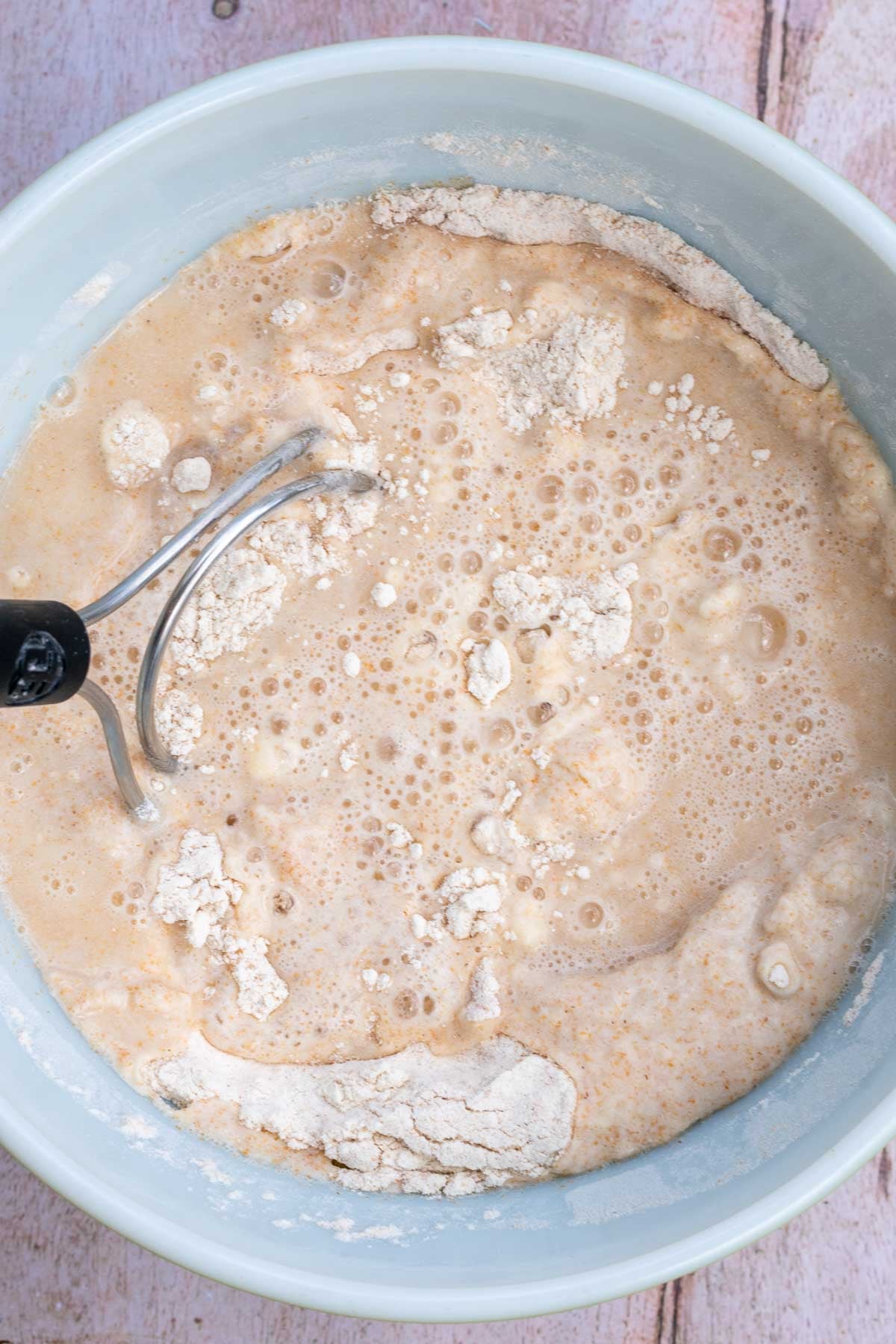 Mixing dough for autolyse with a dough whisk.