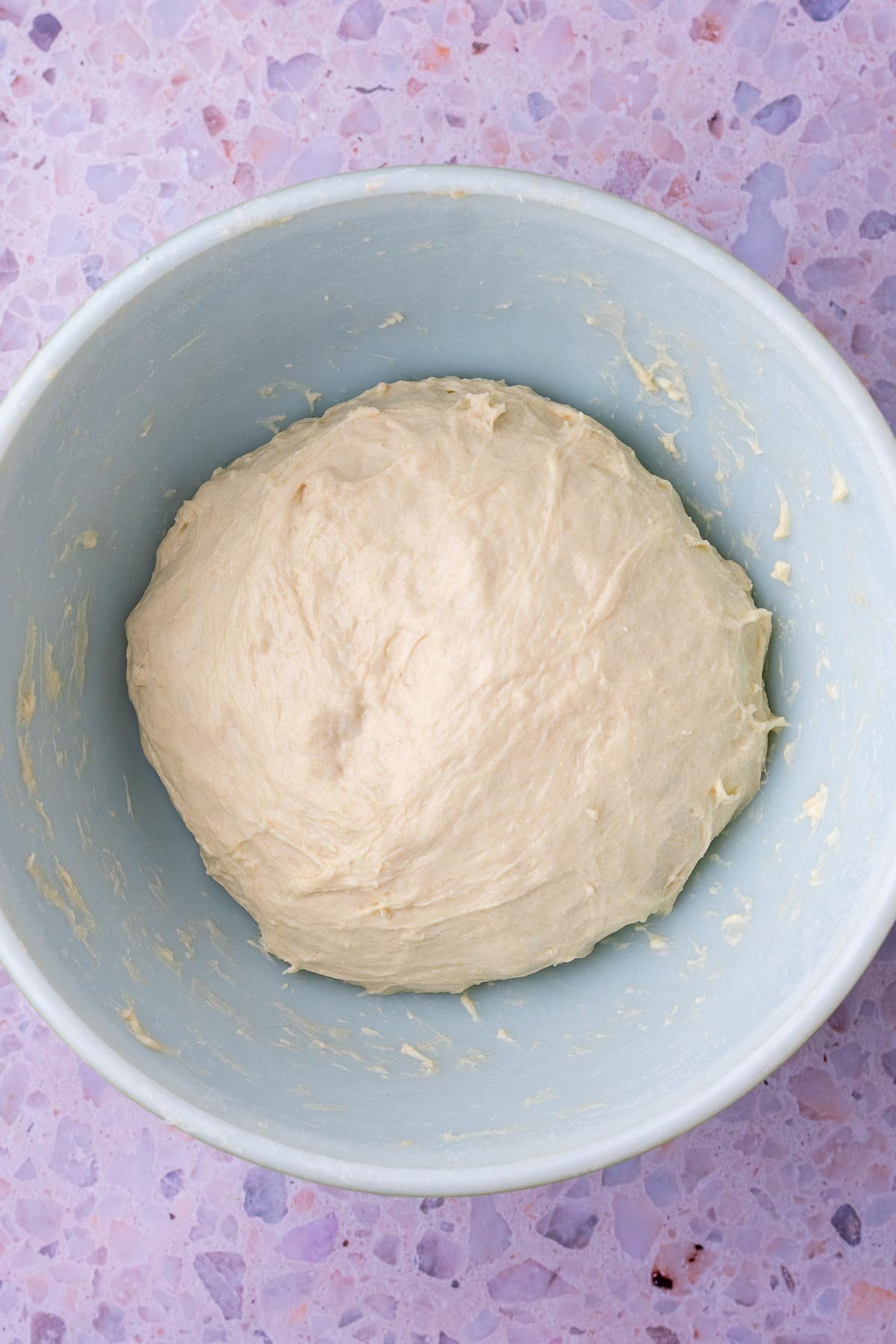 Sourdough baguette dough in a bowl at the start of bulk fermentation.