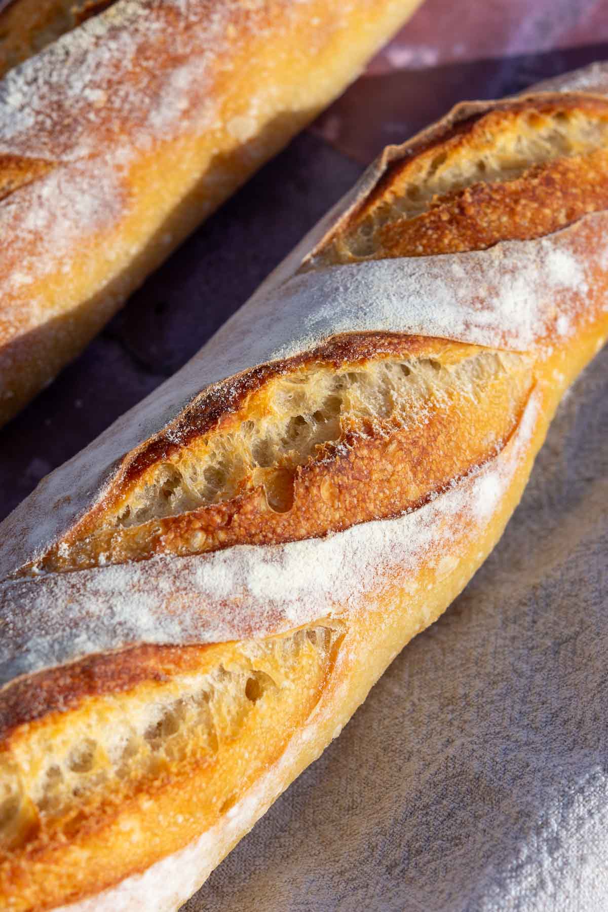 Close up of a sourdough baguette ear.