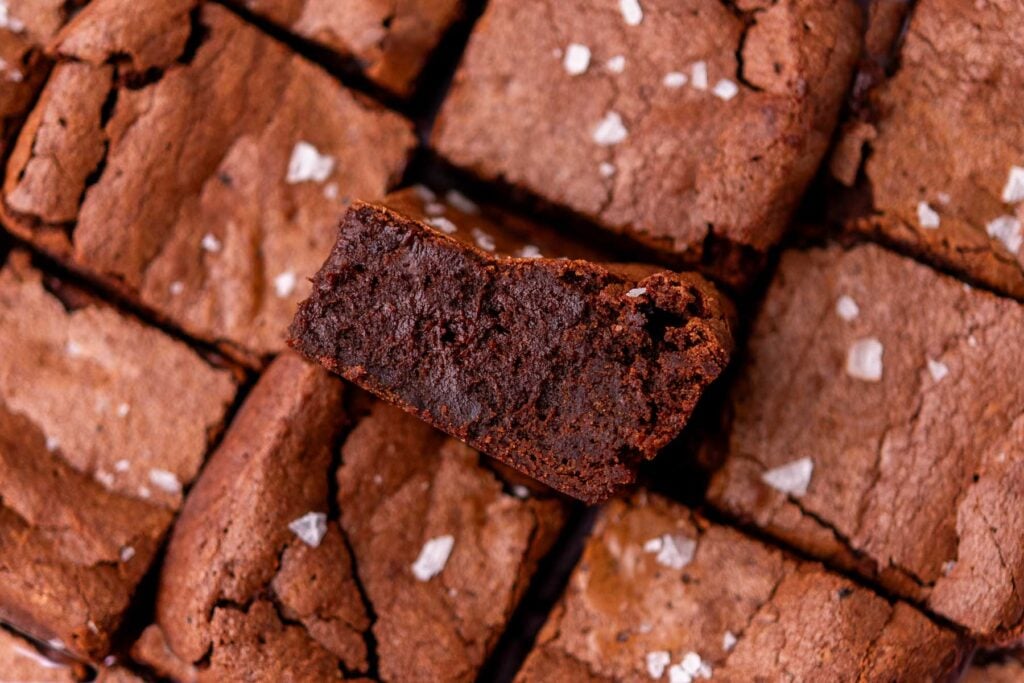 Fudgy sourdough brownies with flaky salt and one in middle turned sideways