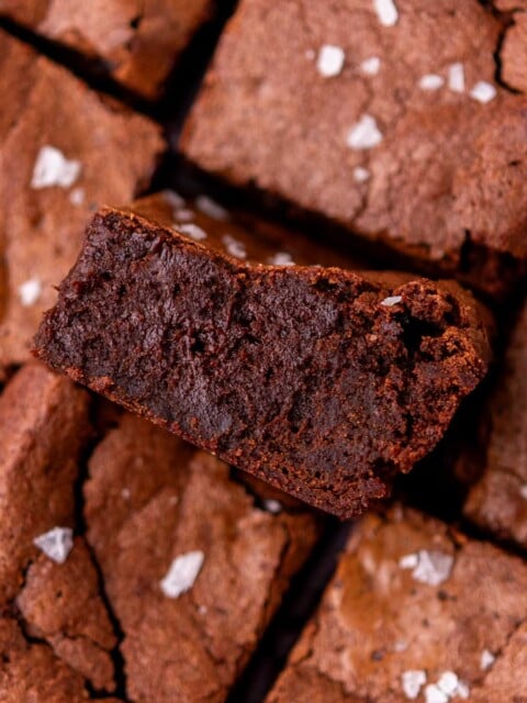 Fudgy sourdough brownies with flaky salt and one in middle turned sideways