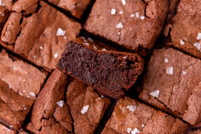 Fudgy sourdough brownies with flaky salt and one in middle turned sideways