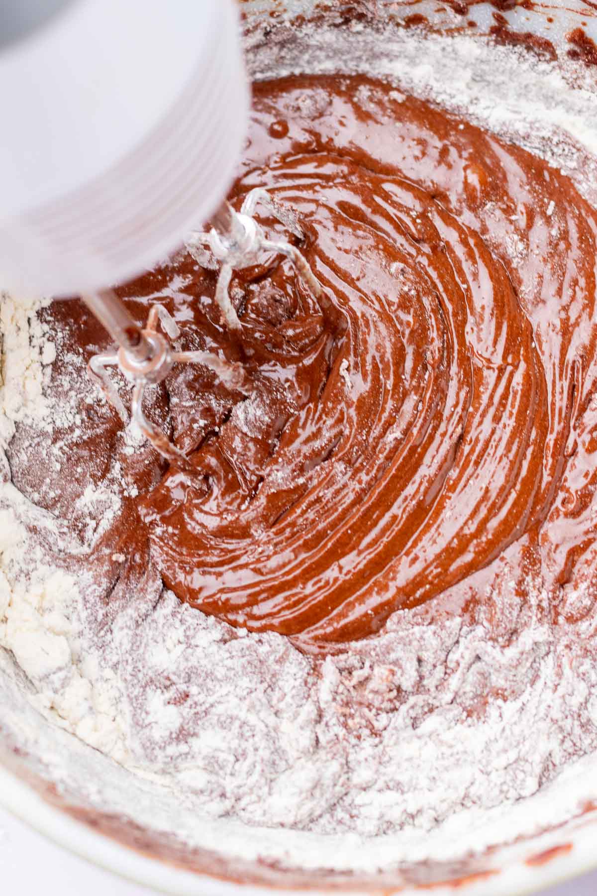 Mixing flour into sourdough brownie batter.