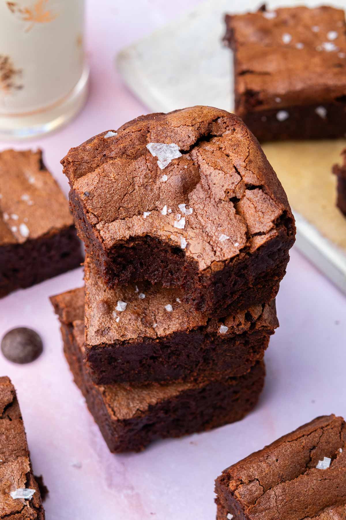 Close up of a stack of fudgy sourdough brownies with crinkly top.